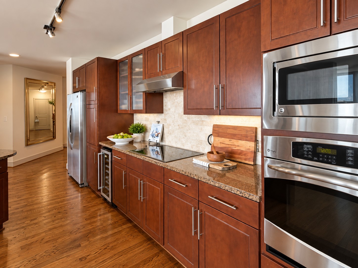 Rich wood cabinetry and sleek stainless-steel appliances bring warmth and sophistication to a kitchen designed for real life. Ample storage and counter space make everything from weeknight dinners to hosting friends feel wonderfully effortless.
