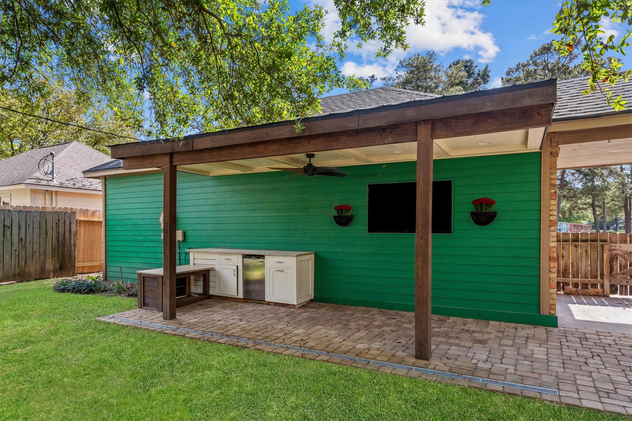 This covered back patio was updated in 2025, including a TV, outdoor kitchen prep area and fridge.