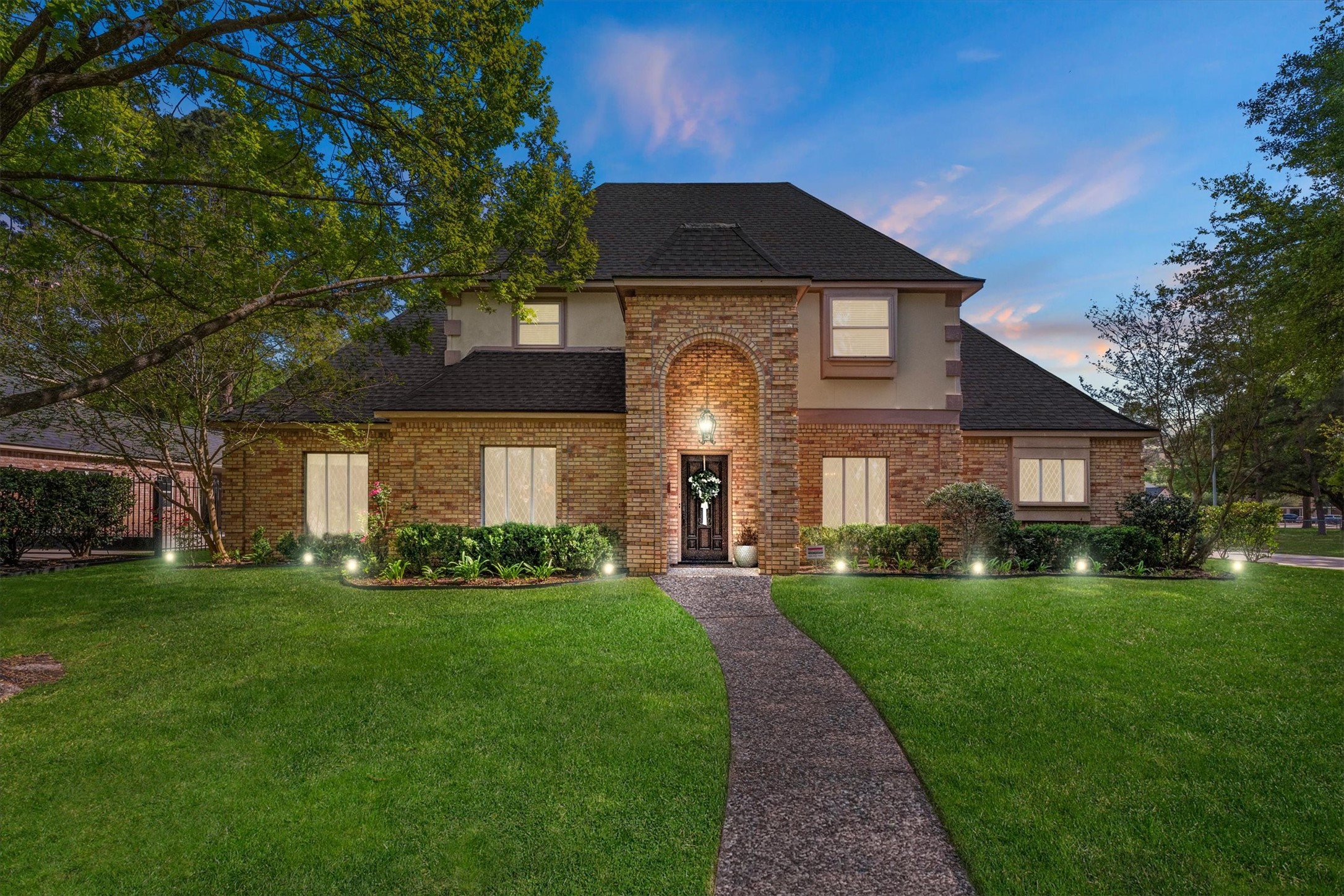 Welcome to 16267 Salmon Lane, an elegant brick home with charming curb appeal in quiet, established Champion Forest.