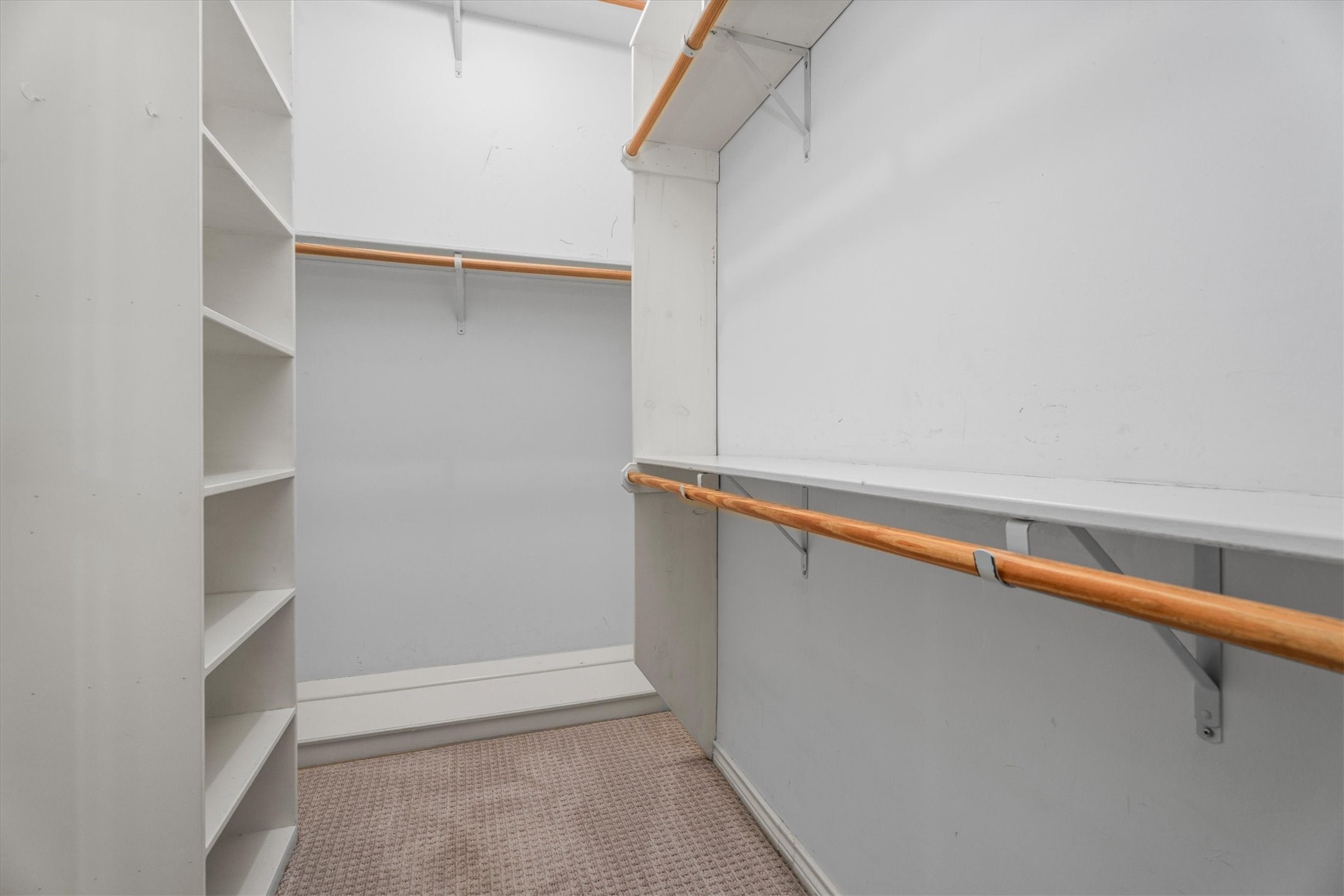 This large walk-in closet offers ample shelving and storage for clothing and accessories.