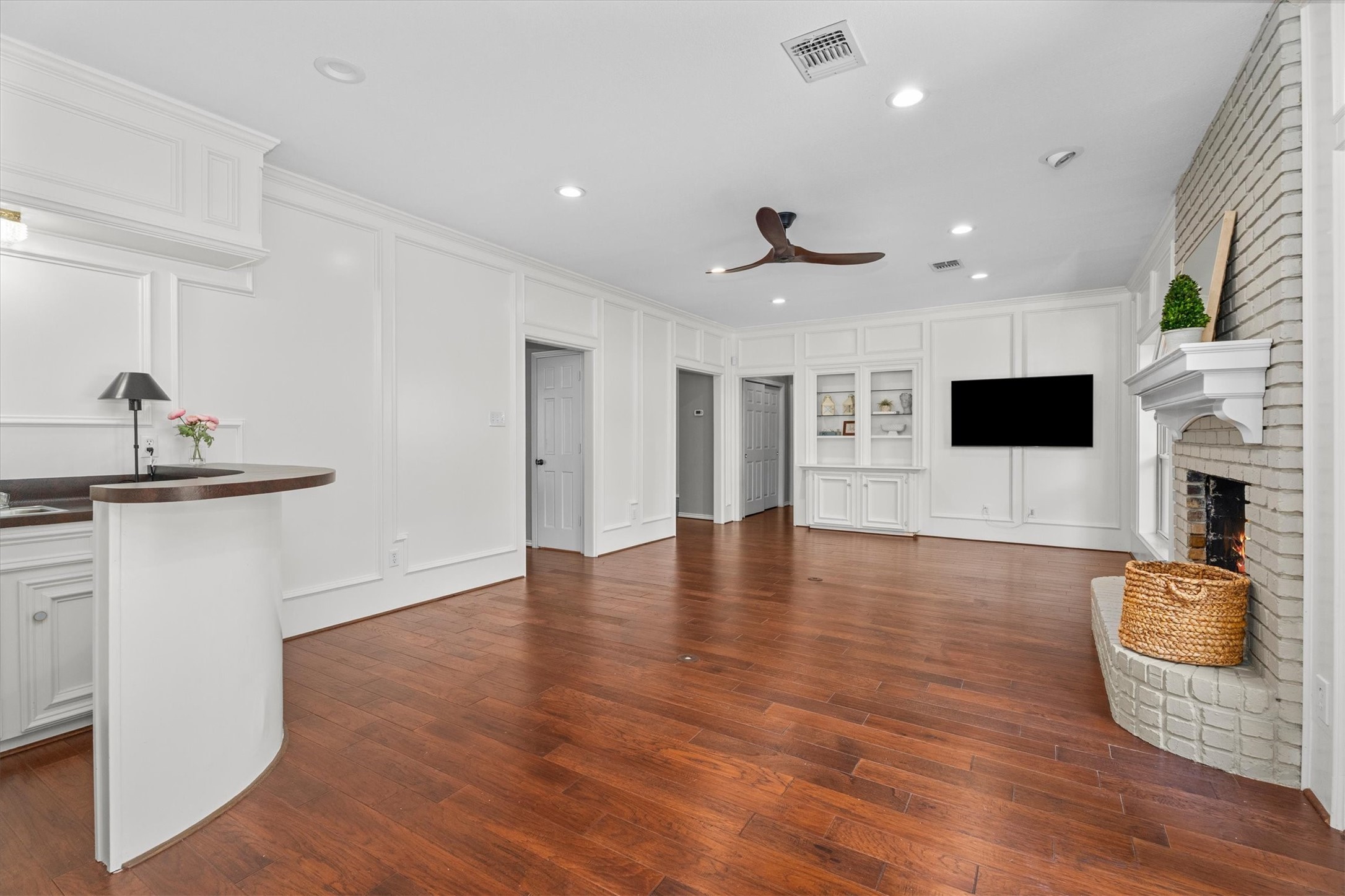 The family room also features built-in cabinets and shelves and a mounted TV on the opposite side (TV coveys). Use the wet bar to showcase your barware, as a coffee bar, or to hide your Amazon boxes!