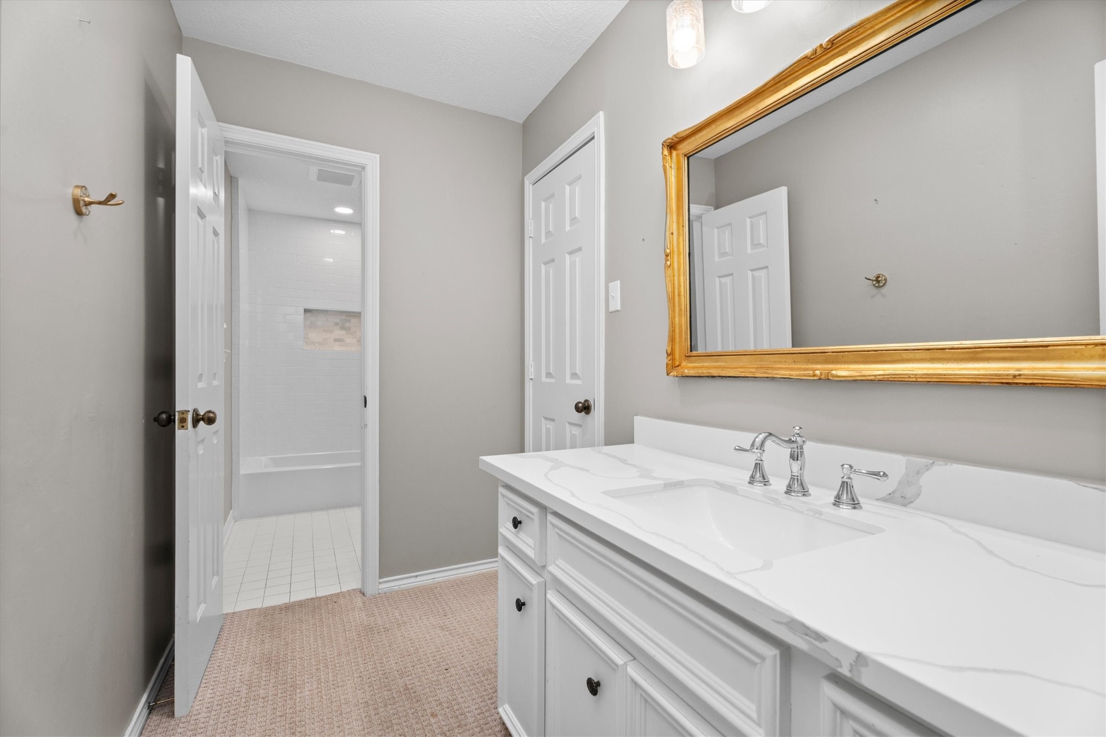 The second sink area is similarly updated, with a walk-in closet to the right.