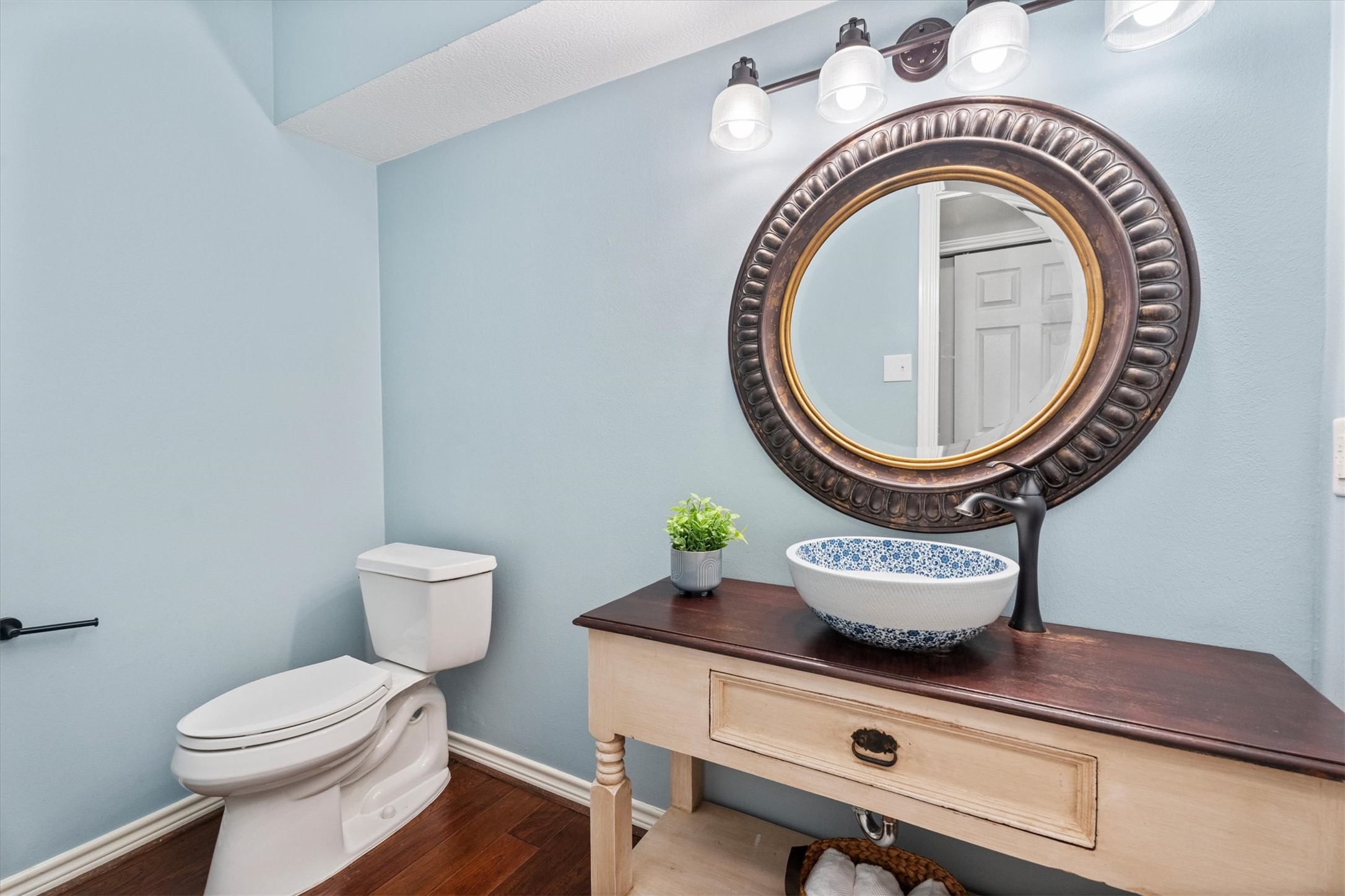 An oversized half bath, updated in 2021, is privately located off the family room, complemented by a lovely vanity and sink.
