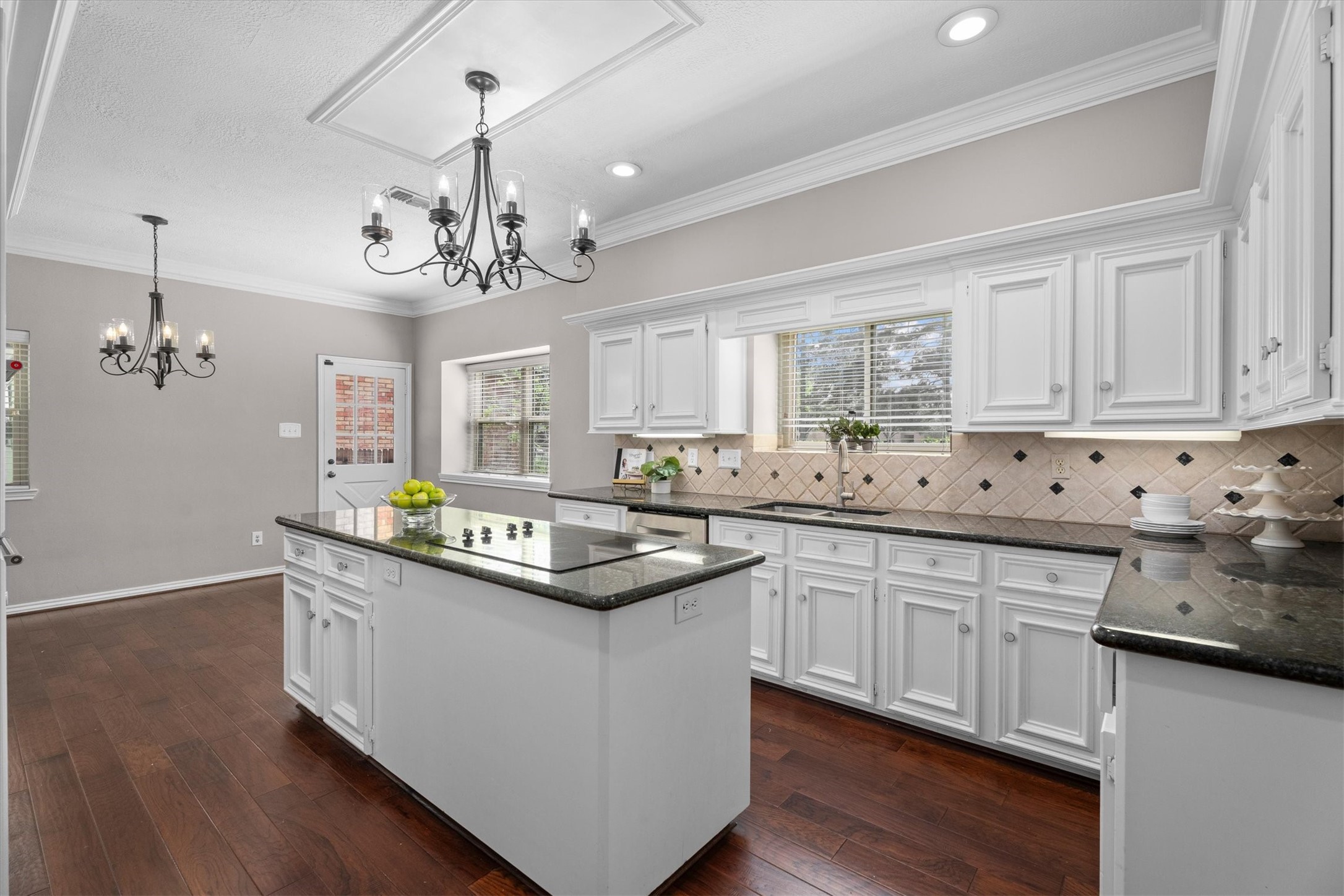 Gorgeous, large kitchen features white cabinets, granite countertops, and lots of light. Appliances updated in 2021. Windows replaced in 2014.