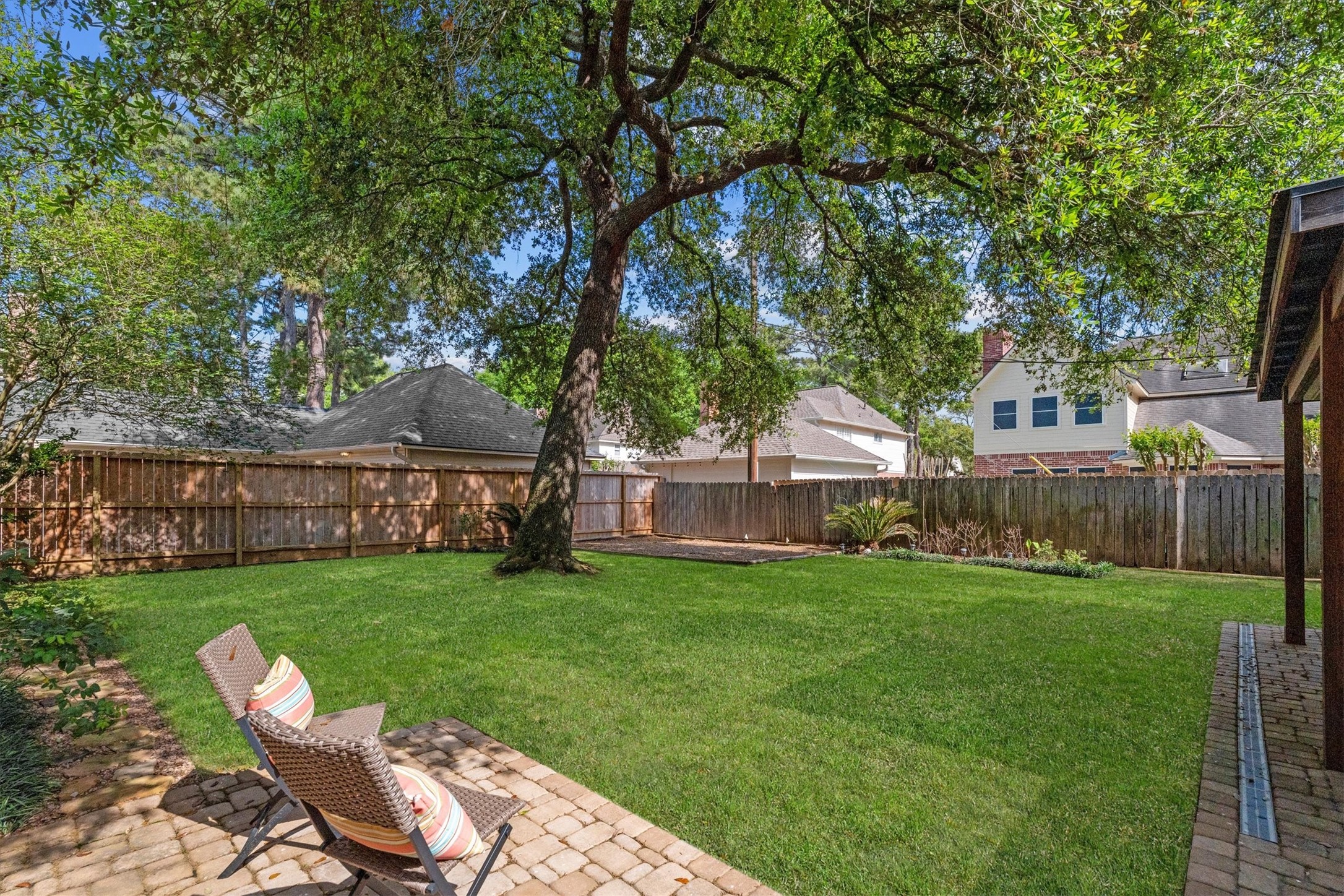 Many options of outdoor seating and entertaining, and a dedicated space for a play set round out the backyard.
