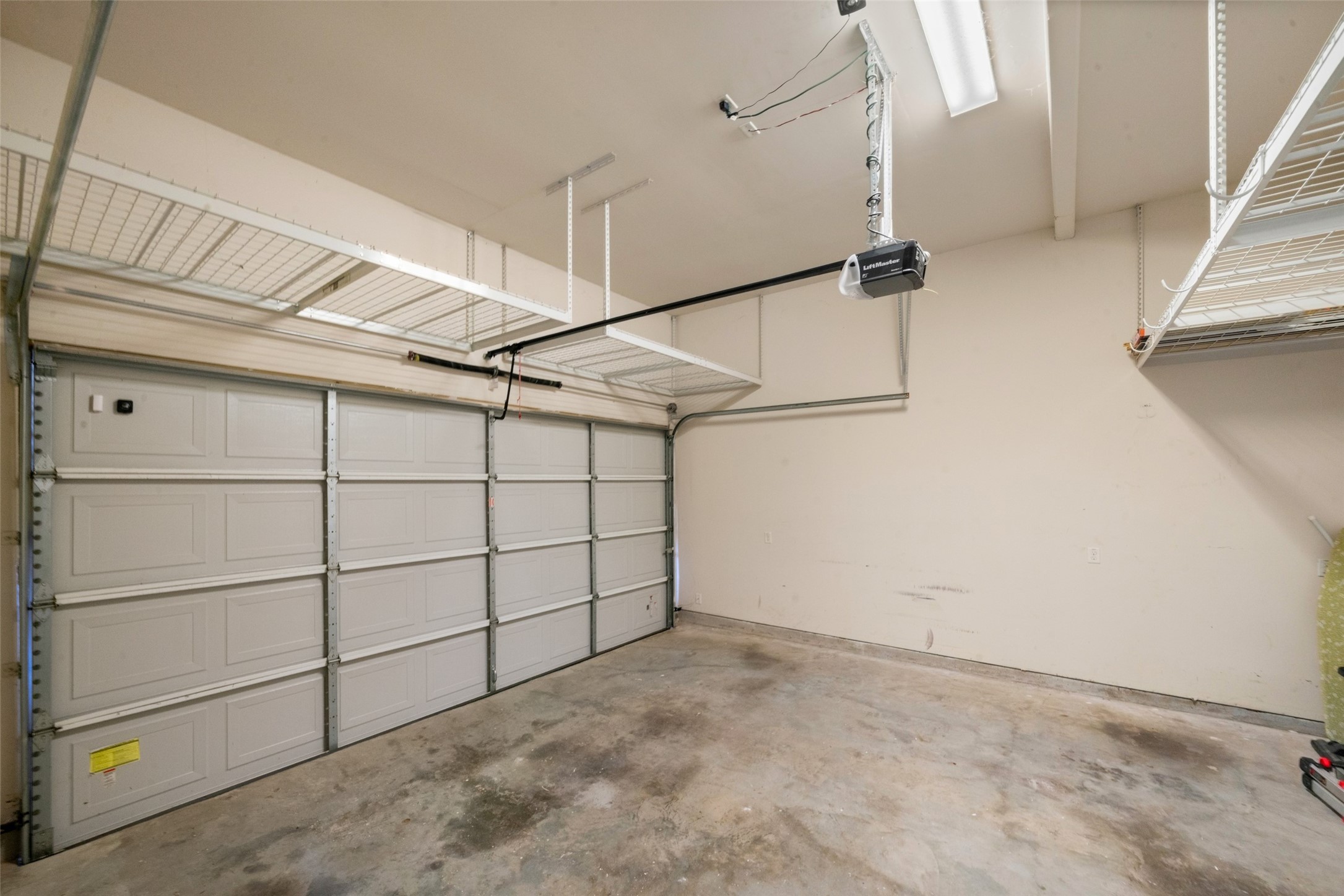 A view of your 2 car garage with loads of overhead storage.