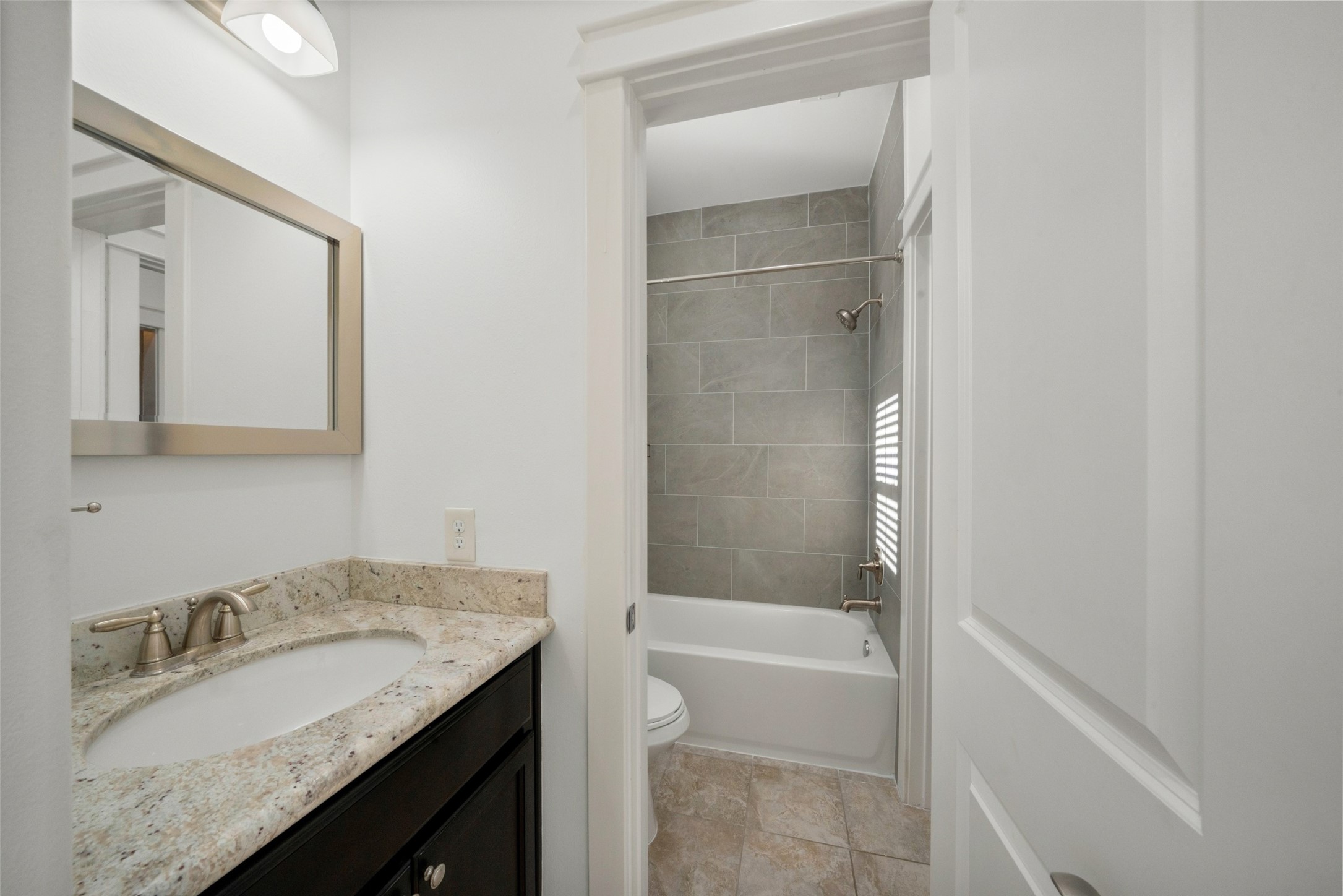 Bathroom access from the 3rd bedroom, not pictured is built in storage to the left. Through the doorway you can see the new tub and tiled shower surround!