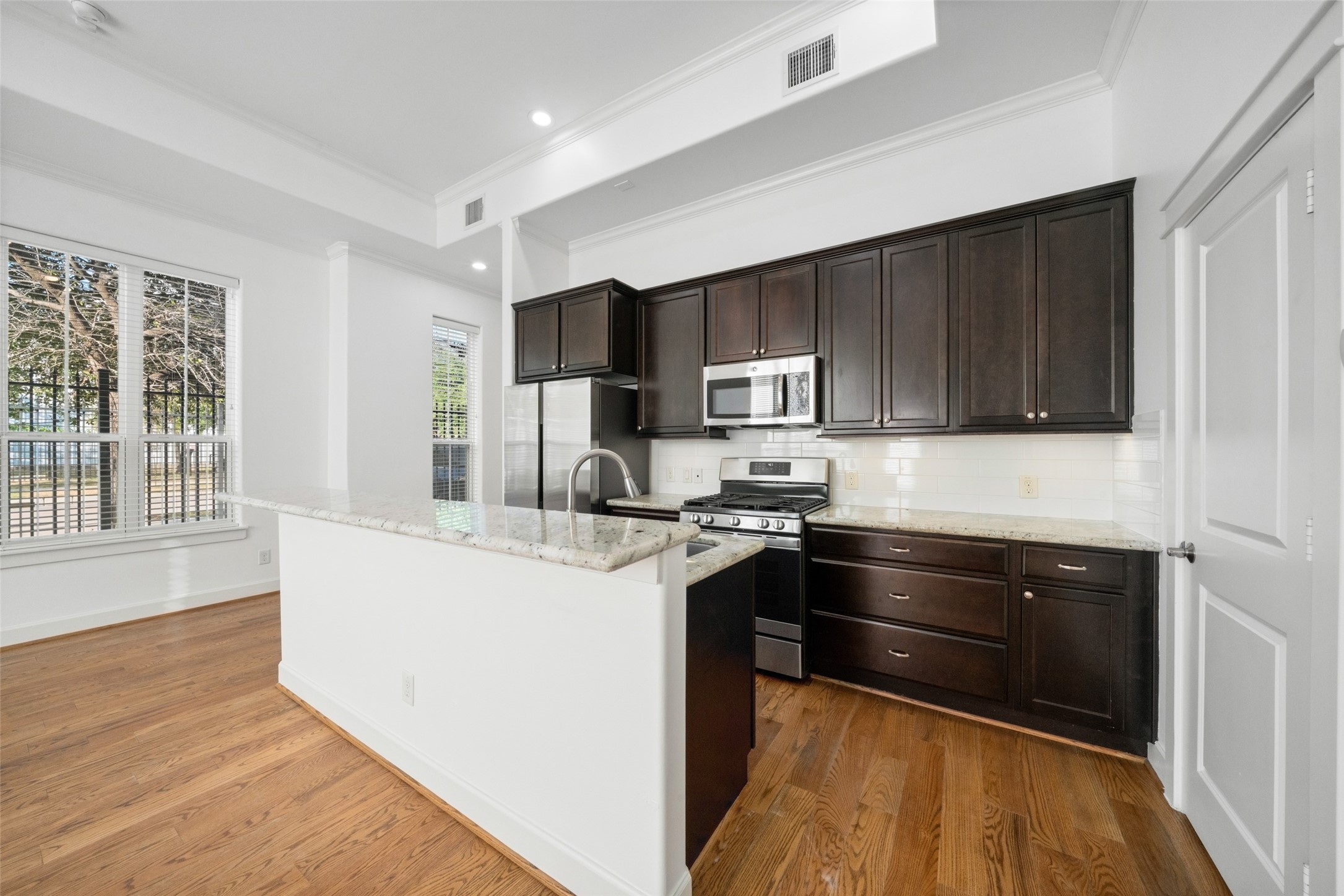 This kitchen comes equipped with stainless steel appliances, including gas range and a NEW double-door refrigerator, granite countertops, under-cabinet lighting, and an island with a sink and eat-at bar. Your large pantry space and under stairs storage closet is through the door to the right. This kitchen comes equipped with stainless steel appliances, including gas range and a NEW double-door refrigerator, granite countertops, under-cabinet lighting, and an island with a sink and eat-at bar. Your large pantry space and under stairs storage closet is through the door to the right.