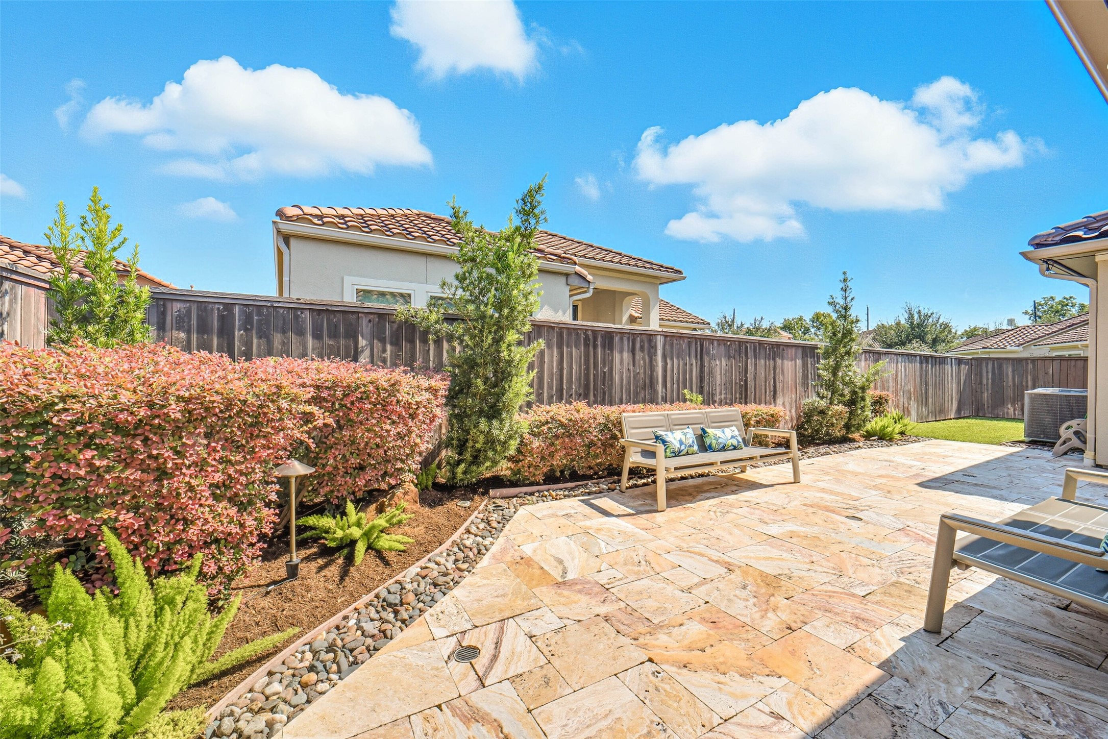 Lovely landscaping enhances the outdoor space.