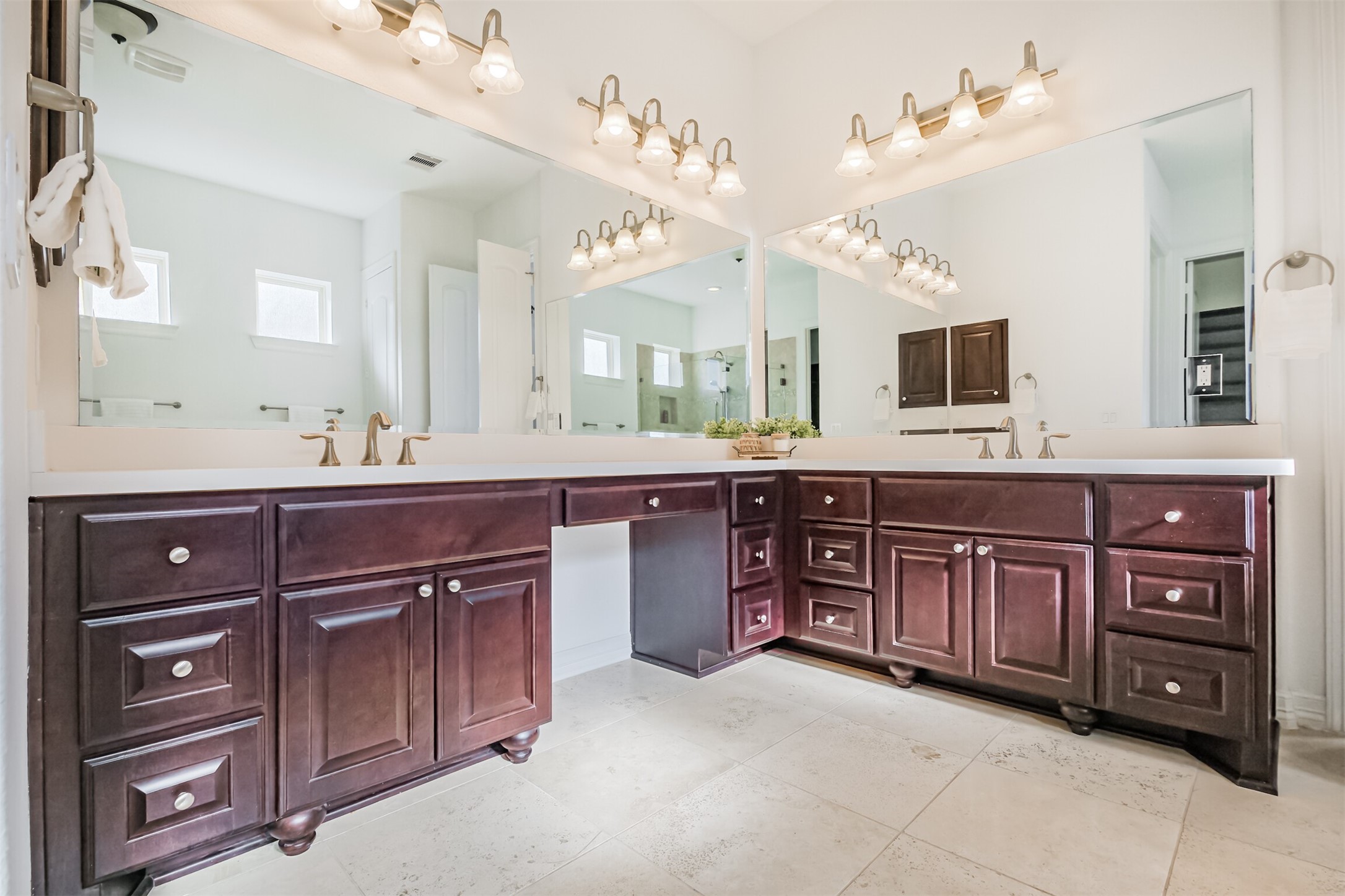 Primary bath featuring double vanities and seating area.