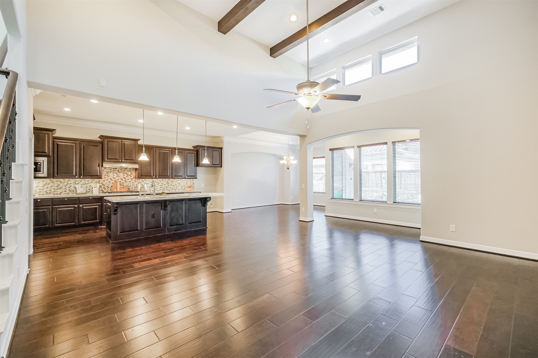 Airy family space highlighted by 14-foot ceilings and ceiling wood beams.