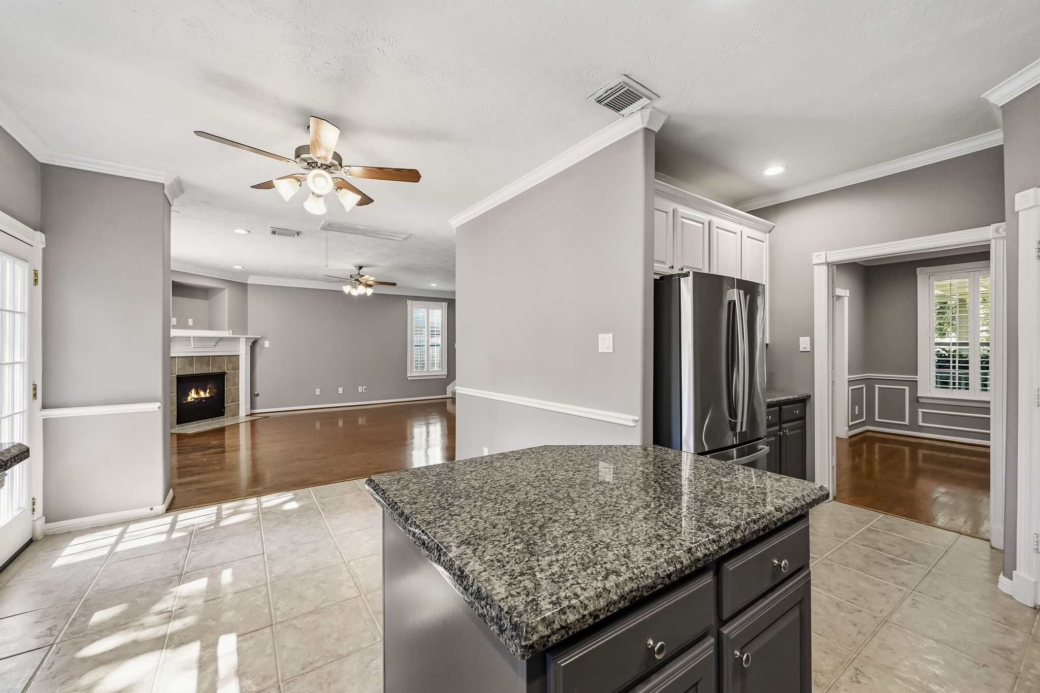 Open kitchen and breakfast area flow into the family room, featuring hardwood floors and a cozy fireplace. Open kitchen and breakfast area flow into the family room, featuring hardwood floors and a cozy fireplace.