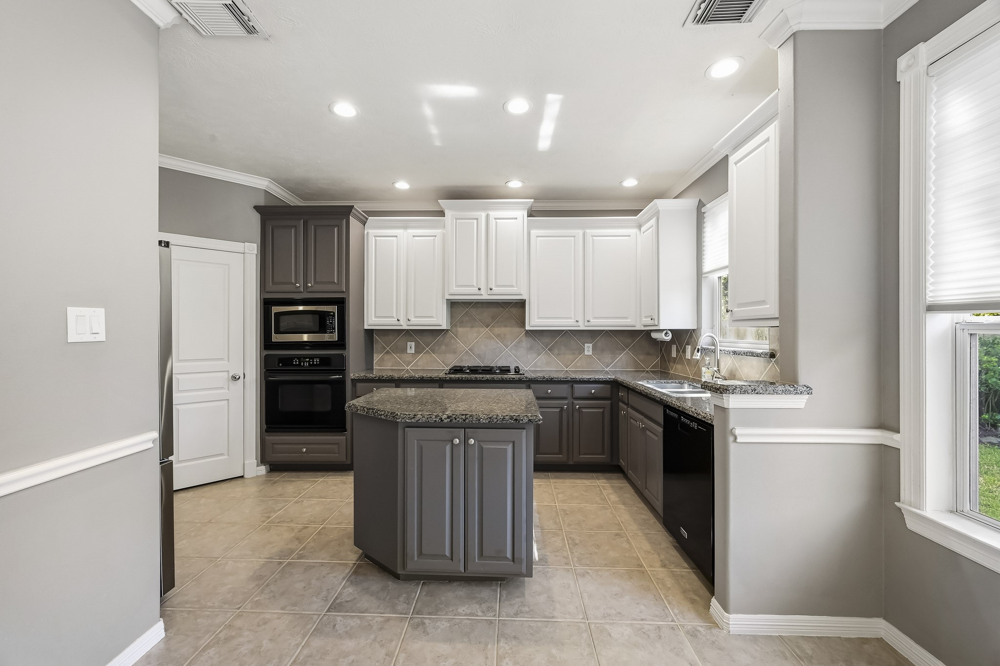 Another view of the kitchen highlighting the generous counter space, center island, and ample cabinetry. Another view of the kitchen highlighting the generous counter space, center island, and ample cabinetry.