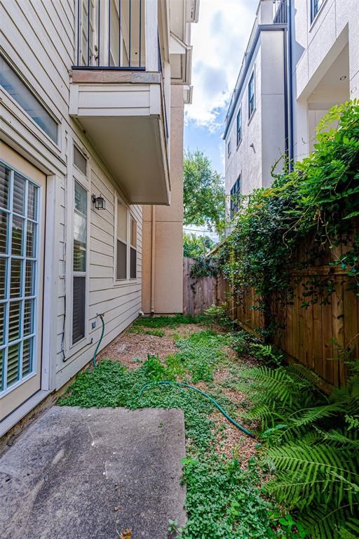 Double doors lead to a small yard outside third bedroom