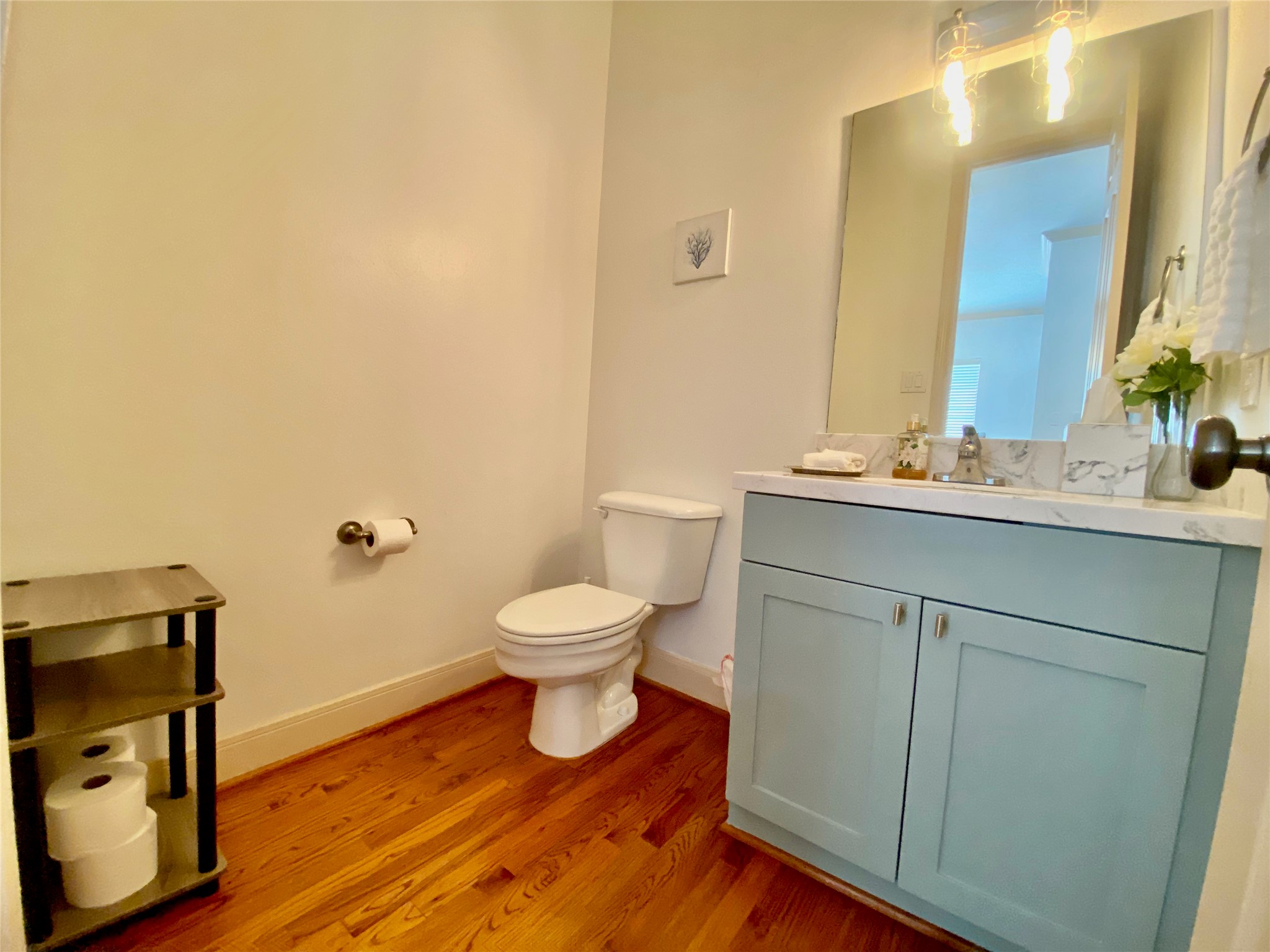 Half bath located right outside kitchen and next to laundry area