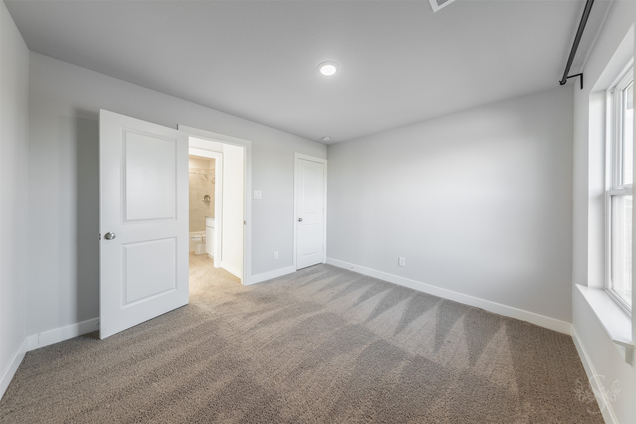Secondary bedroom upstairs features soft carpeting and neutral walls, ready to complement your favorite dcor. Theres plenty of space for a comfortable bed and a desk for homework or creative projects.