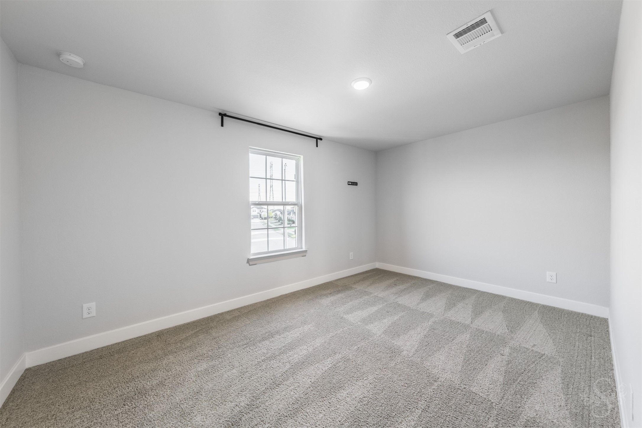 Secondary bedroom upstairs features soft carpeting and neutral walls, ready to complement your favorite dcor. Theres plenty of space for a comfortable bed and a desk for homework or creative projects.