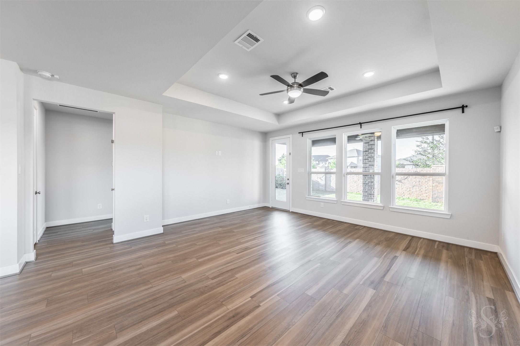 Three large windows brighten the inviting family room while offering views of the back yard. A door to the covered patio makes it easy to take the gathering outside for a relaxing evening with family and friends.