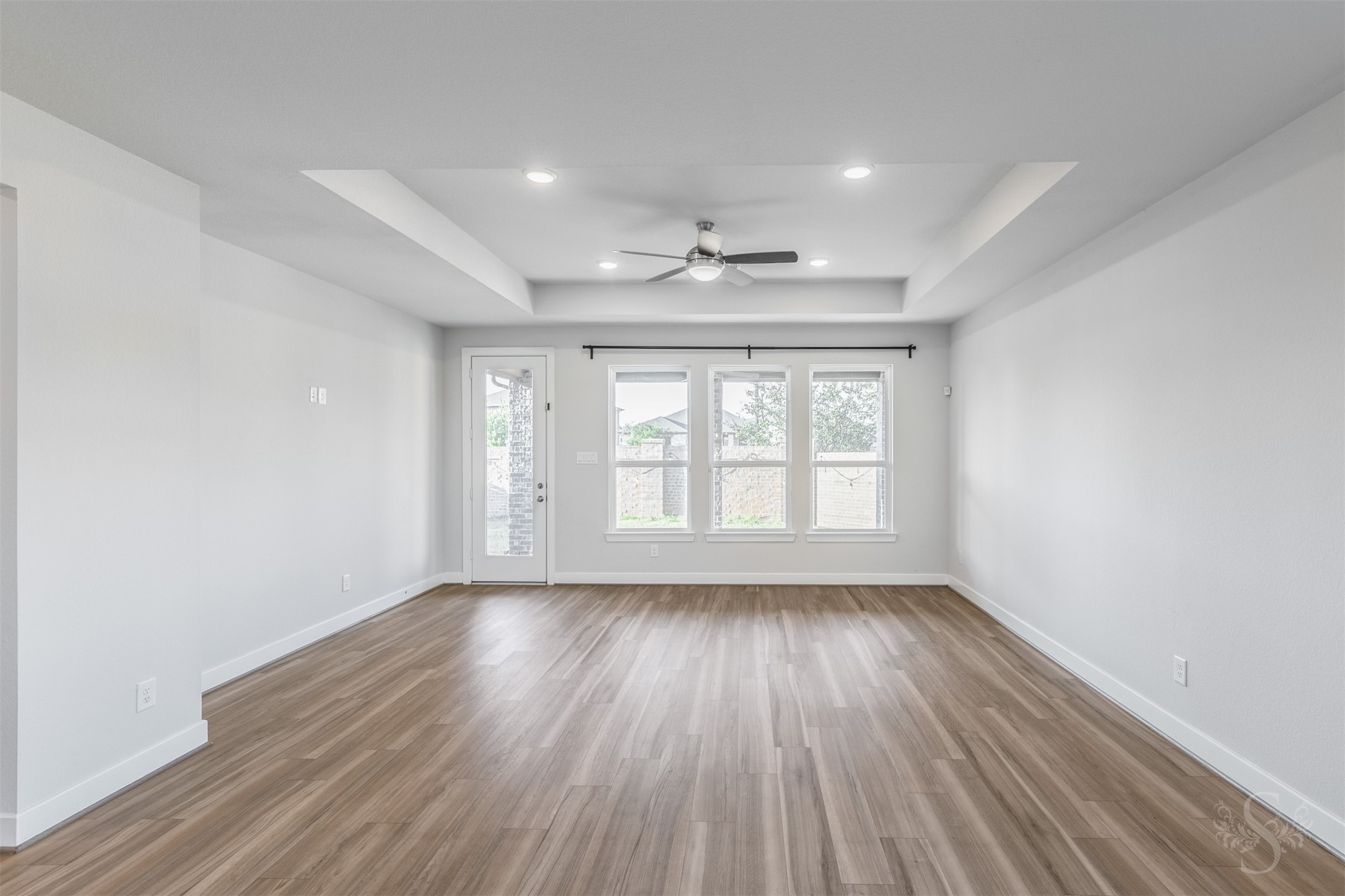 Three large windows brighten the inviting family room while offering views of the back yard. A door to the covered patio makes it easy to take the gathering outside for a relaxing evening with family and friends.