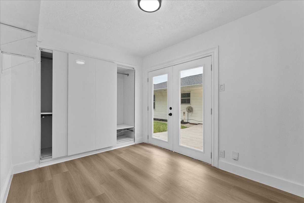 Bright living area with elegant French doors leading to the backyard.