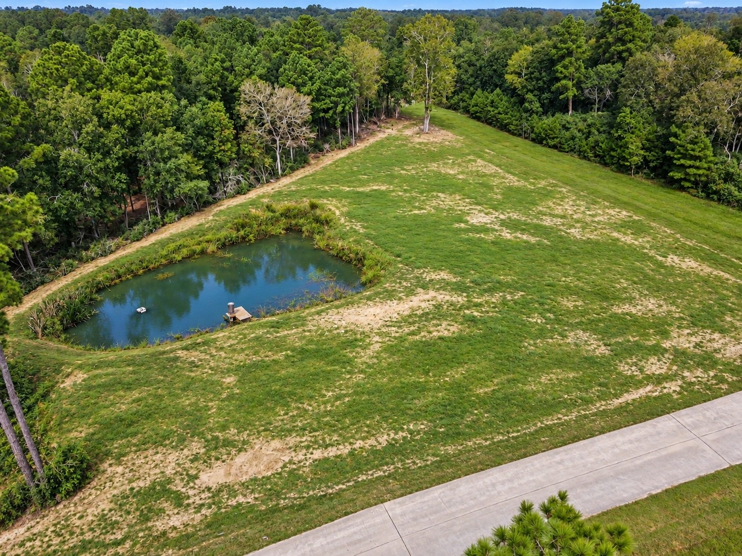 Edited photo to show pond at it's fullest and additional grass grown.