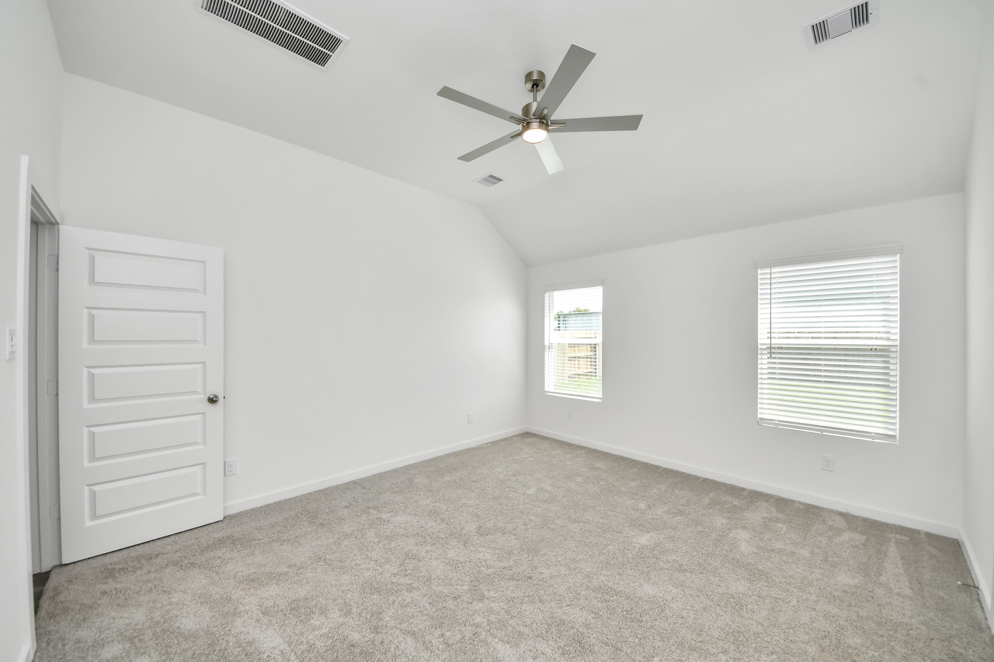 Escape to tranquility in this spacious primary room, adorned with plush carpeting and bathed in the soothing hues of warm paint colors, creating a cozy retreat for relaxation. Sample photo of completed home with similar floor plan. Actual colors and selections may vary.