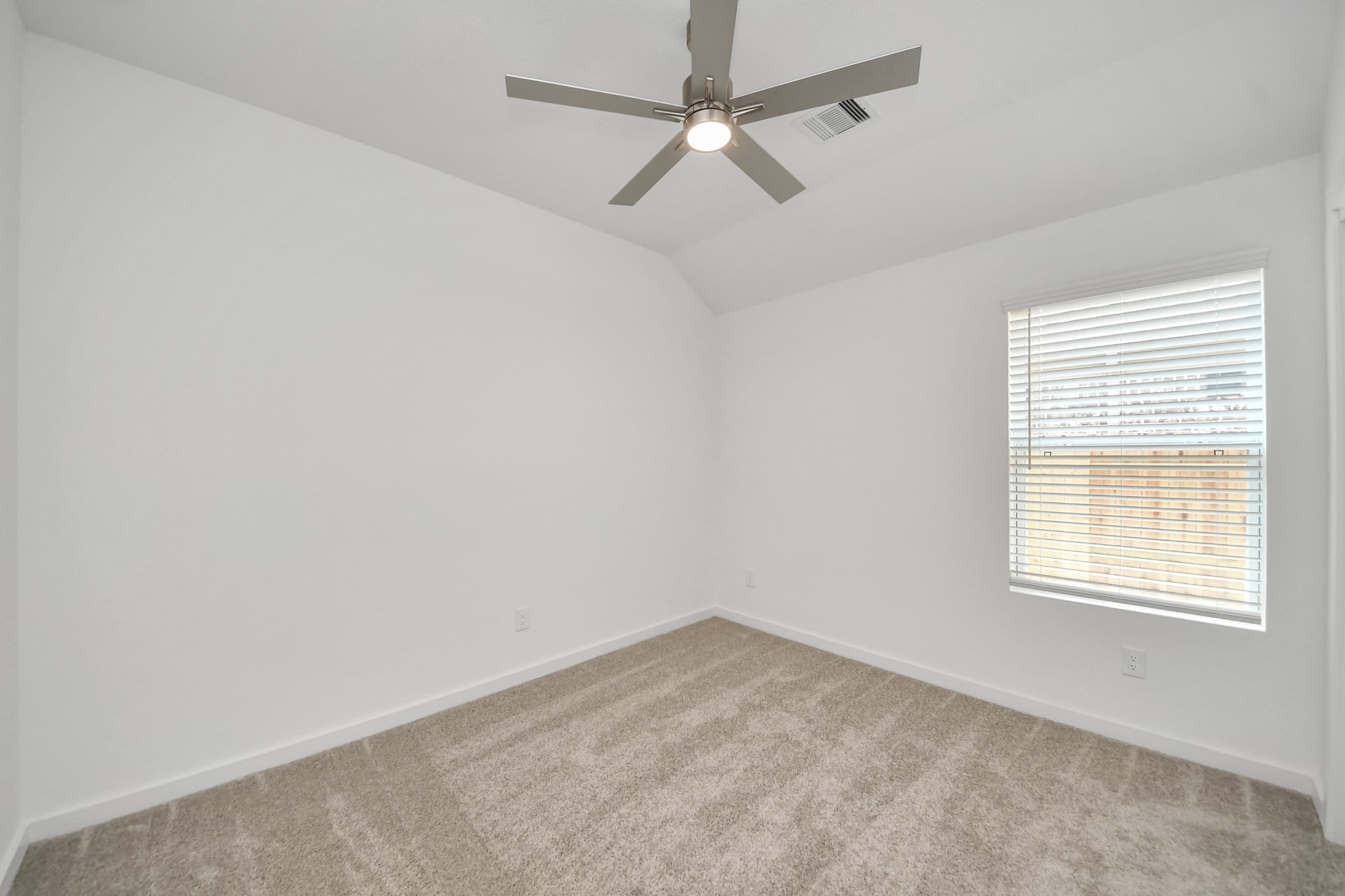 Secondary bedroom features plush carpeting, large windows that let in plenty of natural light, bright paint, and spacious closets. Sample photo of completed home with similar floor plan. Actual colors and selections may vary.
