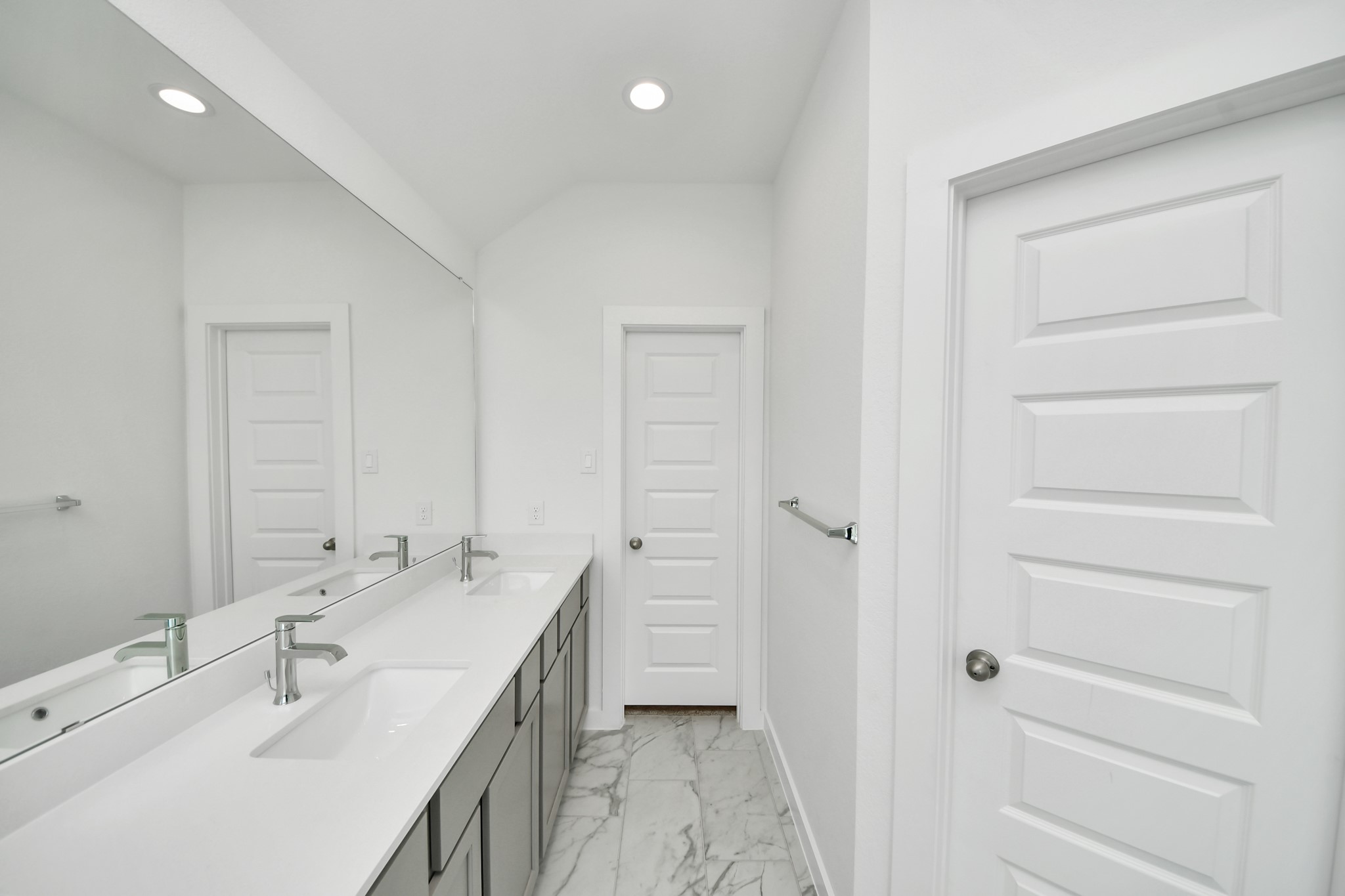 Indulge in a spa-like retreat within the confines of this primary bathroom. Delight in a spacious walk-in shower enveloped in stylish tile surround, unwind in a separate garden tub adorned with custom detailing. Sample photo of completed home with similar floor plan. Actual colors and selections may vary.