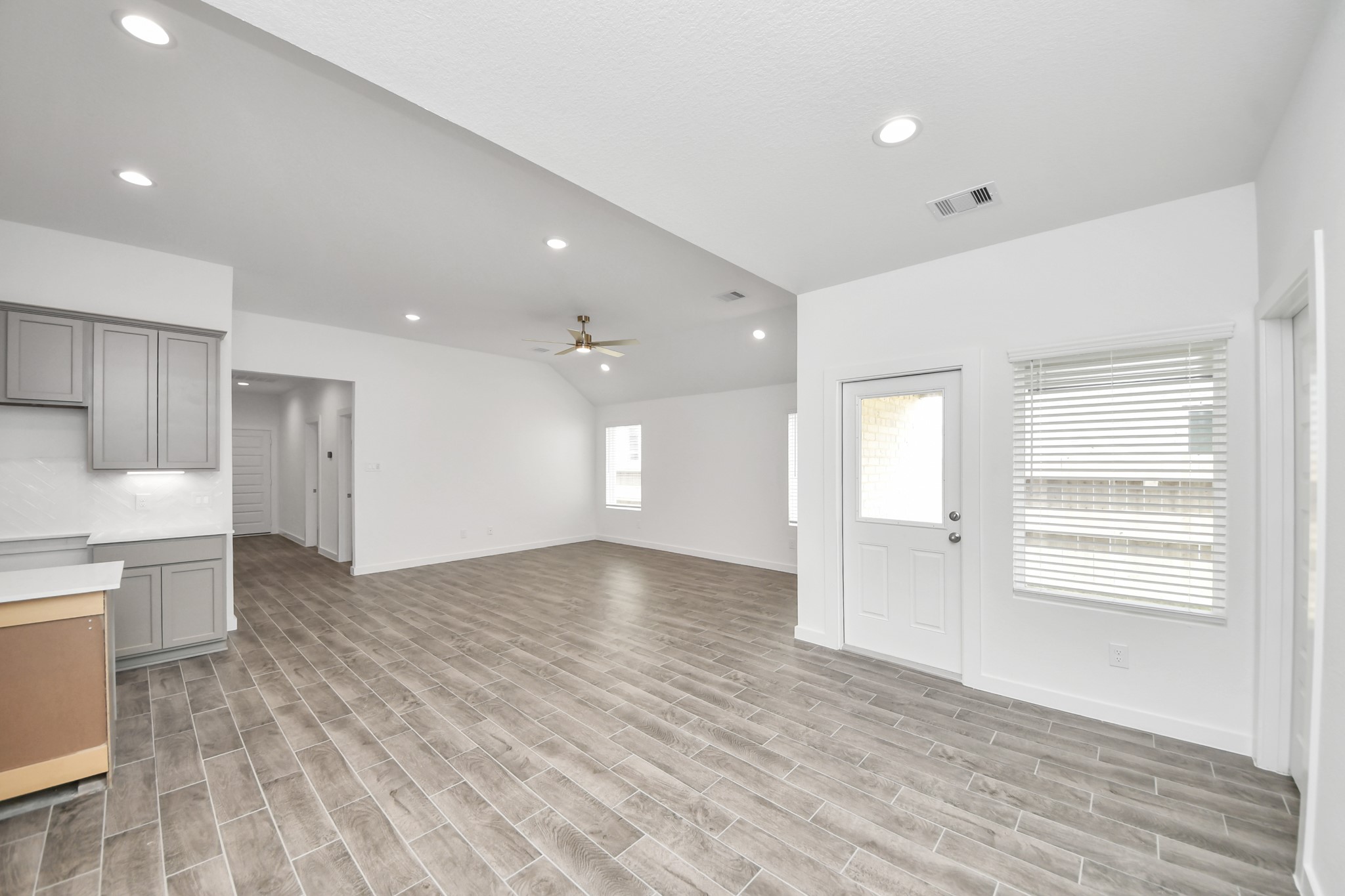 Create lasting memories with your family and friends at the dining table! This expansive dining room showcases sophisticated flooring, custom paint, and seamlessly connects to the family room and kitchen, providing an open and inviting atmosphere. Sample photo of completed home with similar floor plan. Actual colors and selections may vary.
