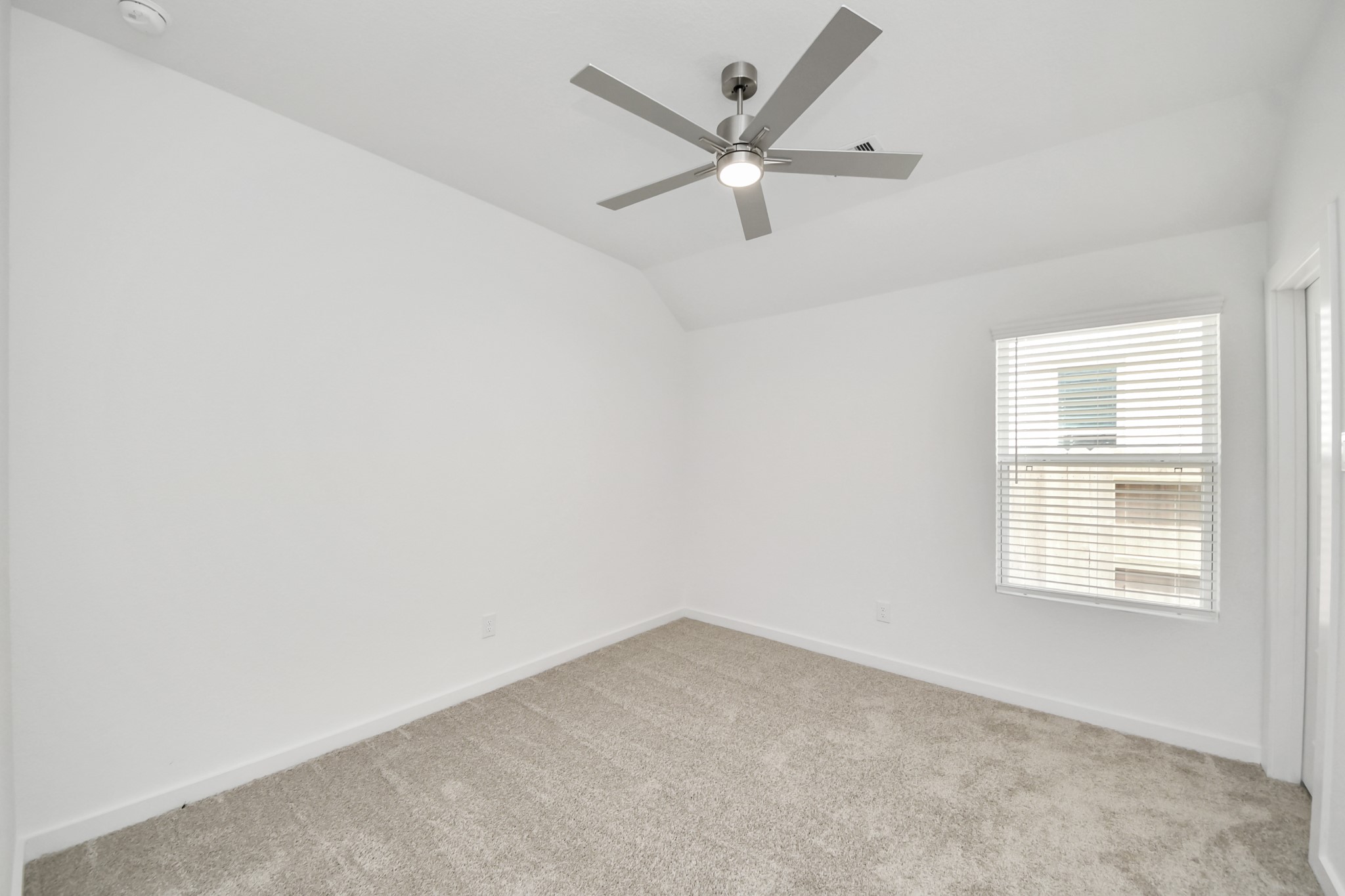 Secondary bedroom features plush carpeting, large windows that let in plenty of natural light, bright paint, and spacious closets. Sample photo of completed home with similar floor plan. Actual colors and selections may vary.