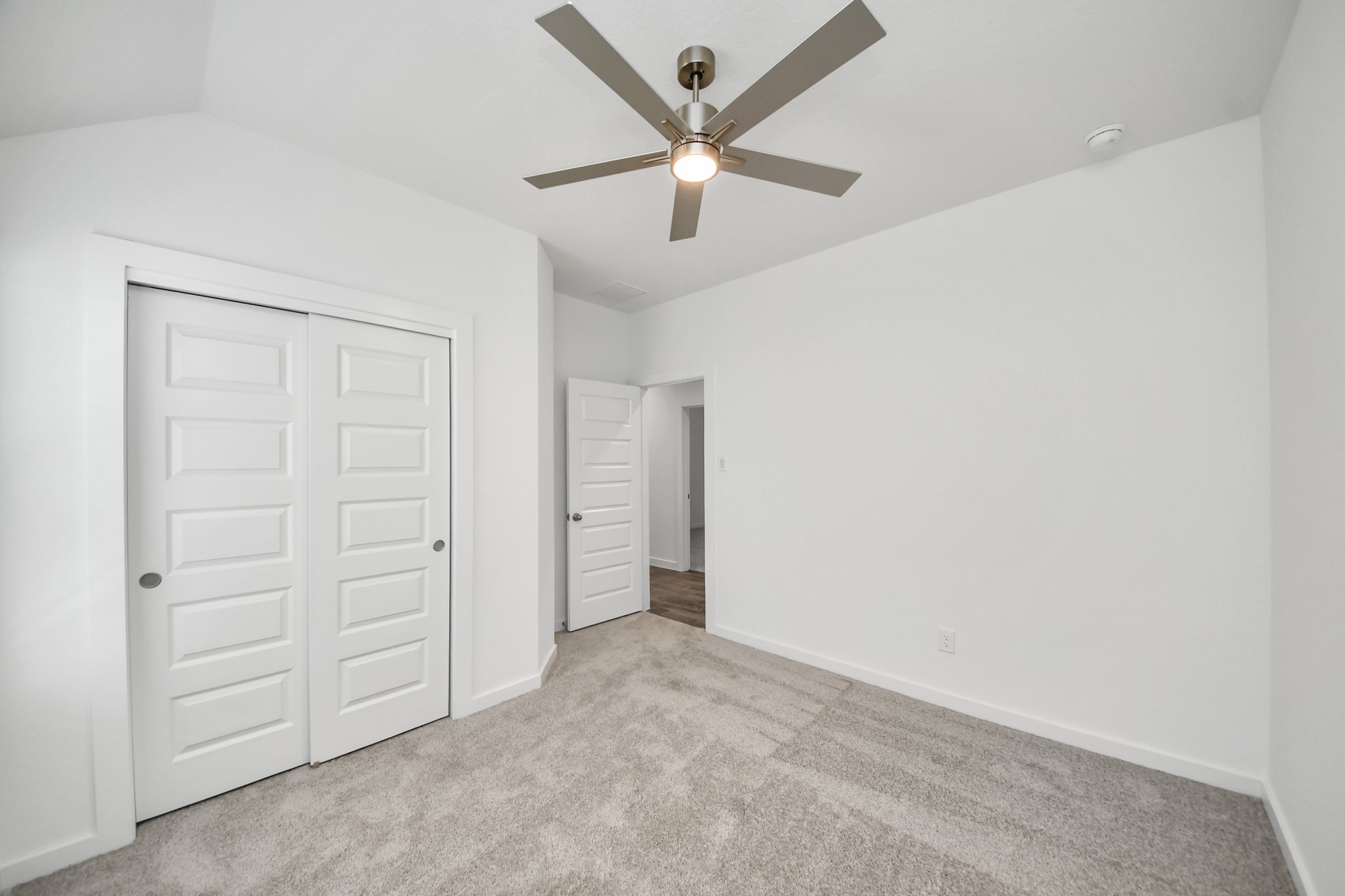 Generously sized secondary bedrooms featuring spacious closets, soft and inviting carpeting underfoot, large windows allowing plenty of natural light, and the added touch of privacy blinds for your personal retreat. Sample photo of completed home with similar floor plan. Actual colors and selections may vary.