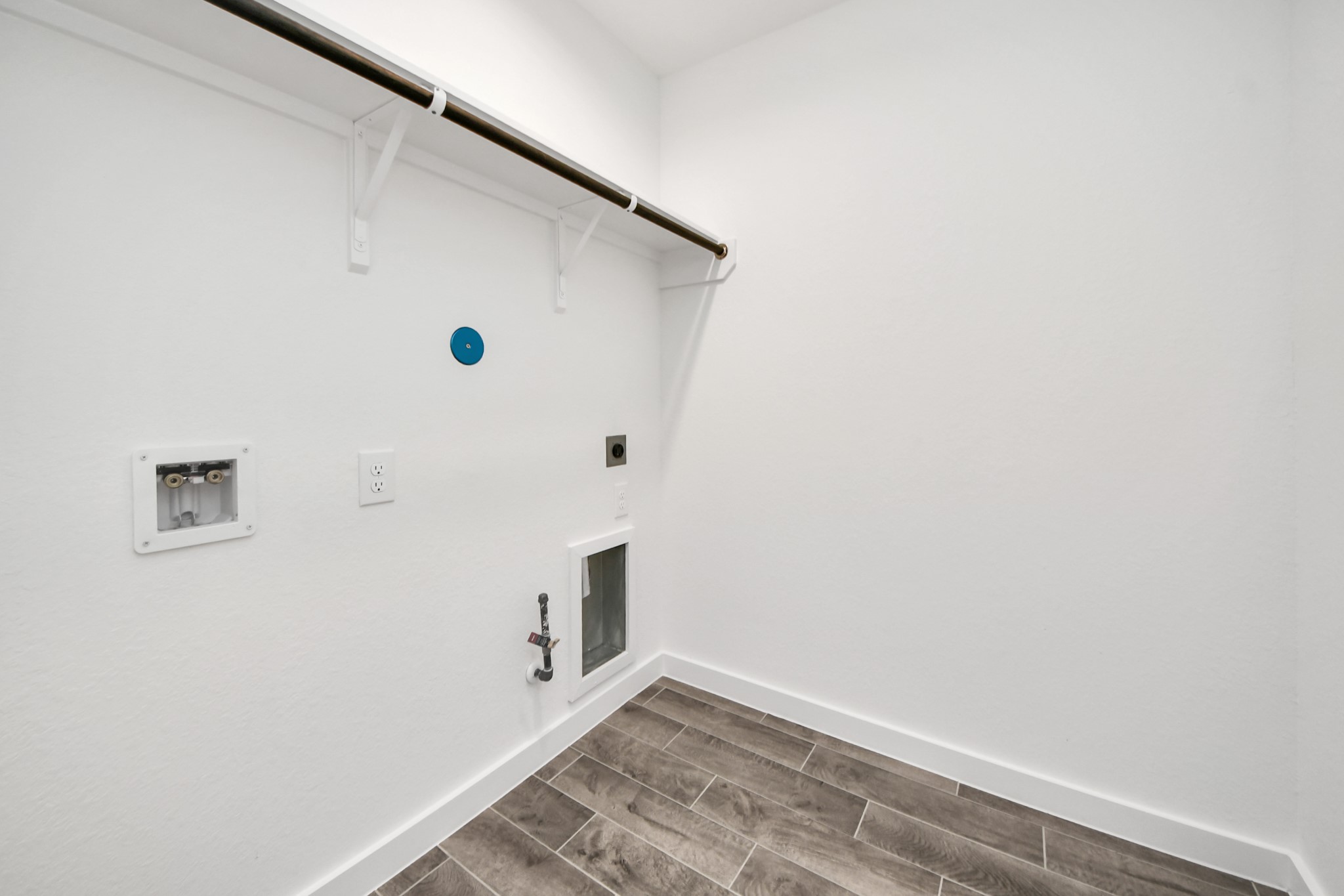 A perfect blend of functionality and comfort. Capture the essence of easy living with a first-floor laundry room, thoughtfully equipped with shelving for effortless organization. Both electric and gas connections available. Sample photo of completed home with similar floor plan. Actual colors and selections may vary.