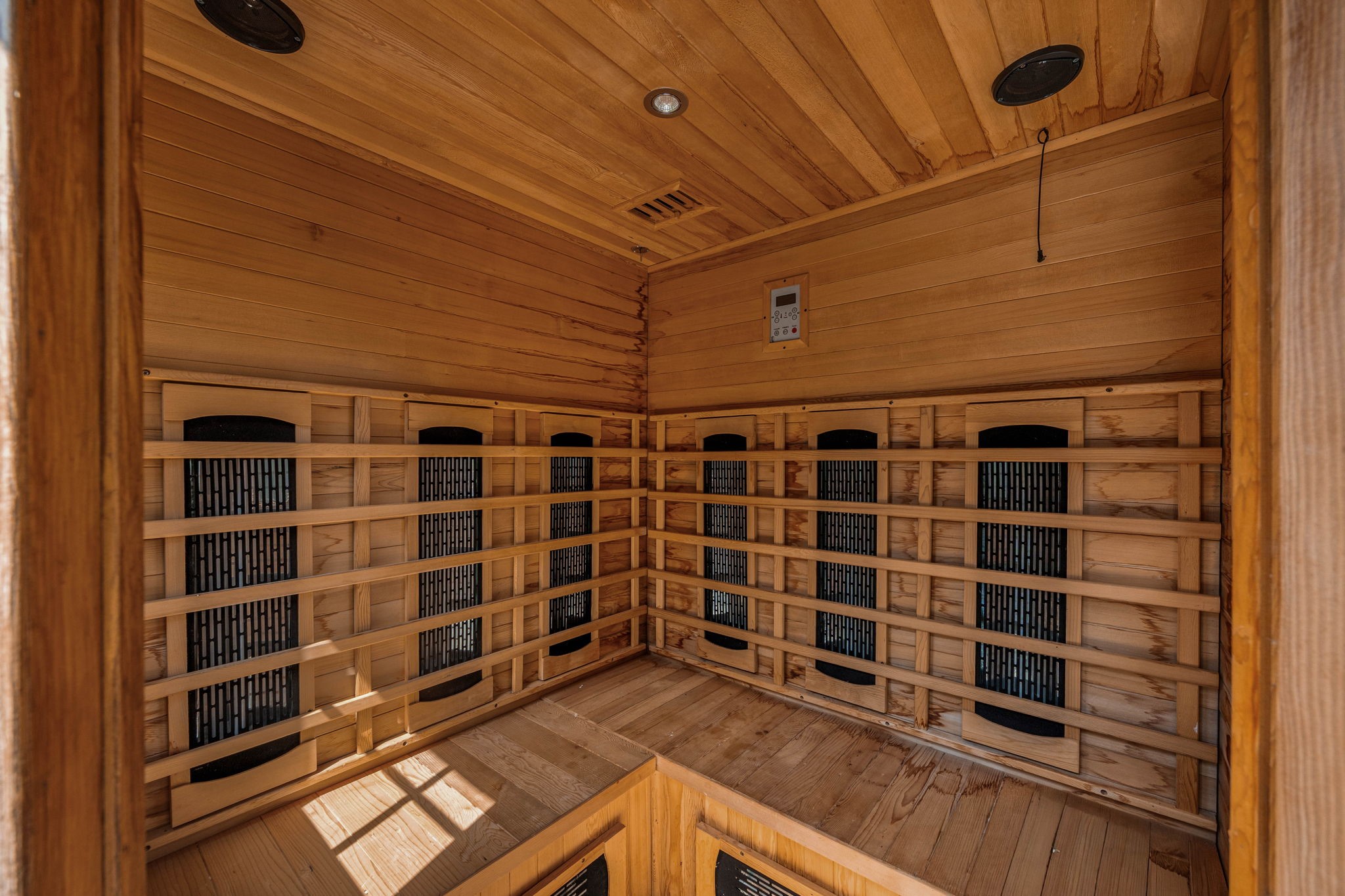Step inside the private backyard wellness oasis to discover a premium, fully lined cedar infrared sauna that elevates this property to a true luxury retreat. The beautifully crafted interior features multi-level bench seating, integrated wall-mounted heating panels for an efficient and soothing experience, recessed ceiling lighting, built-in audio speakers, and a digital climate control panel to easily customize your relaxation sessions.