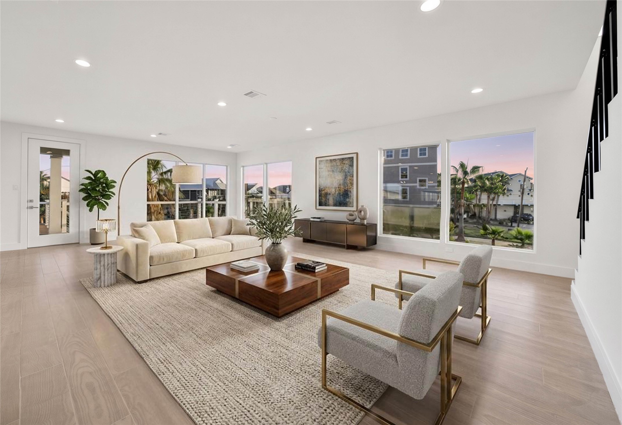 Open living space surrounded by windows that fill the room with natural light and showcase the views. Door leads to the amazing second floor deck for easy indoor/outdoor entertaining! *virtually staged*
