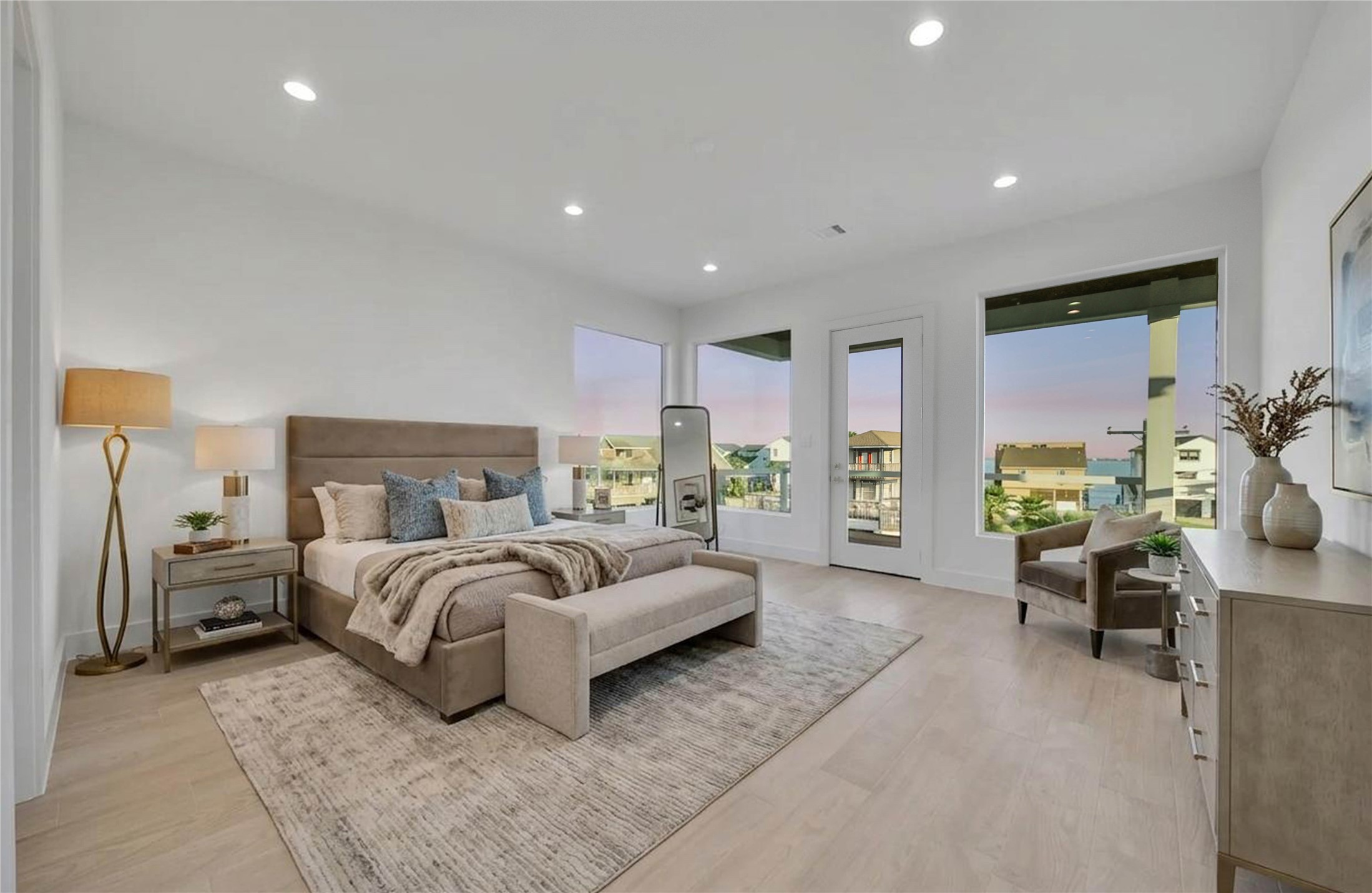 Generously sized primary bedroom with abundant natural light, patio access, and plenty of room for a sitting area.