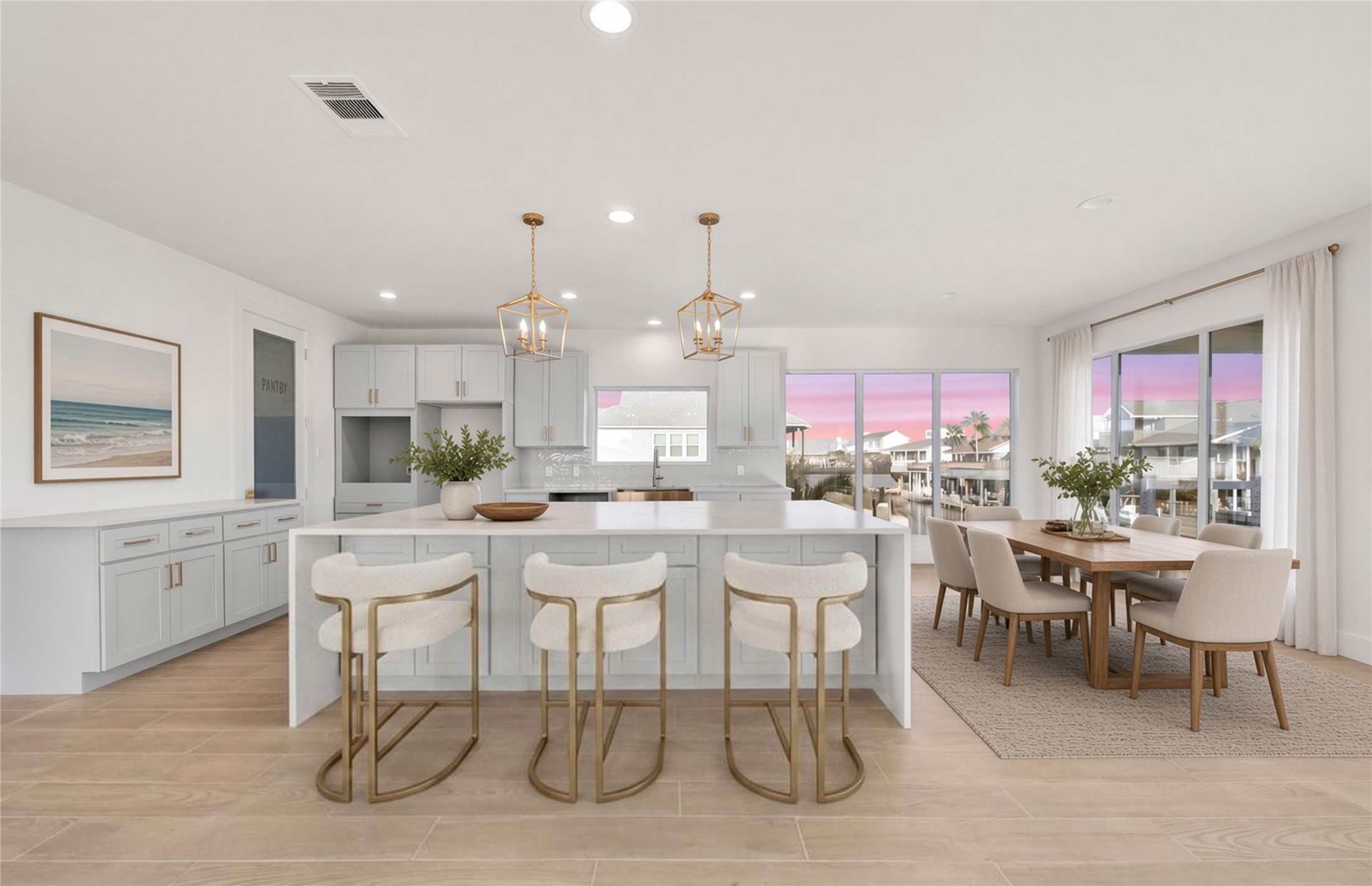Completely remodeled from the ground up, this light-filled kitchen features an open layout, spacious island, and breathtaking views of the canal. *virtually staged*
