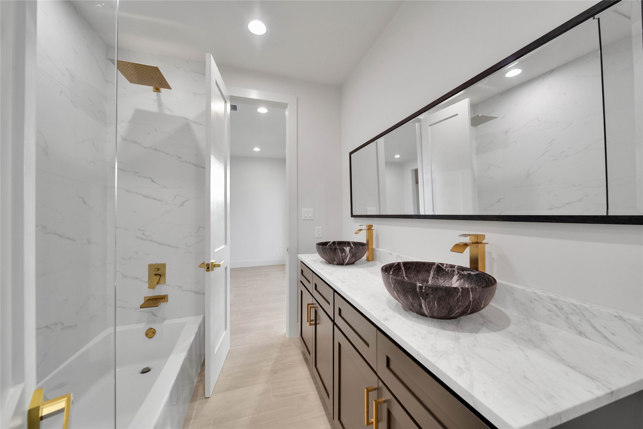 Well-appointed secondary bathroom featuring a spacious double sink vanity and clean, modern finishes.