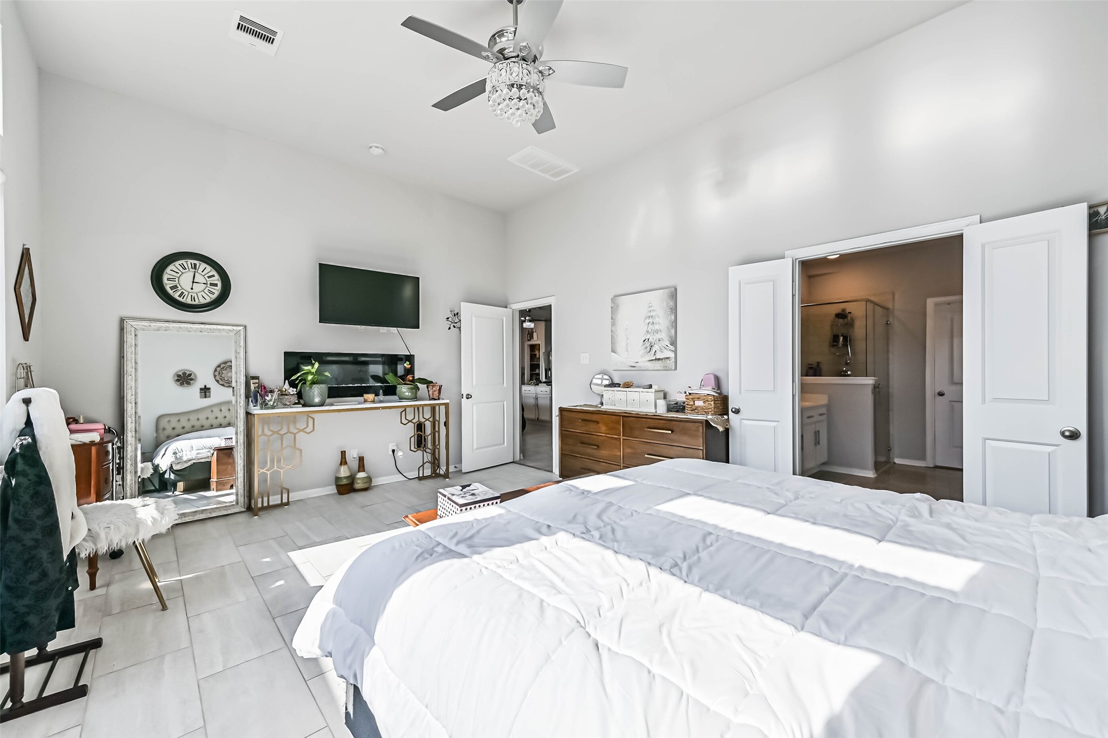 Another view of the generously sized primary suite, showcasing its spacious layout and direct access to the private bathroom.