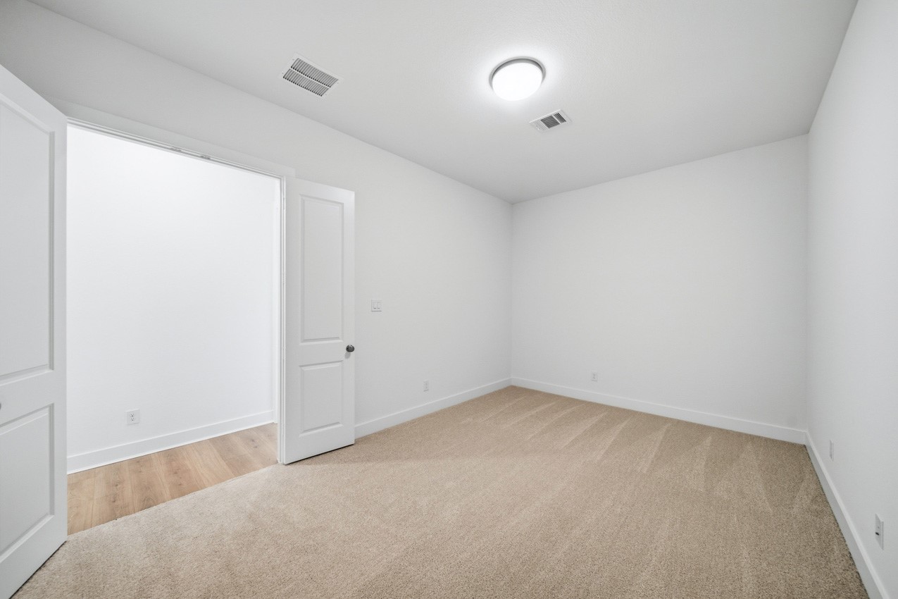 Flexible entertainment room ideal for a media room, home gym, playroom, or additional living space
