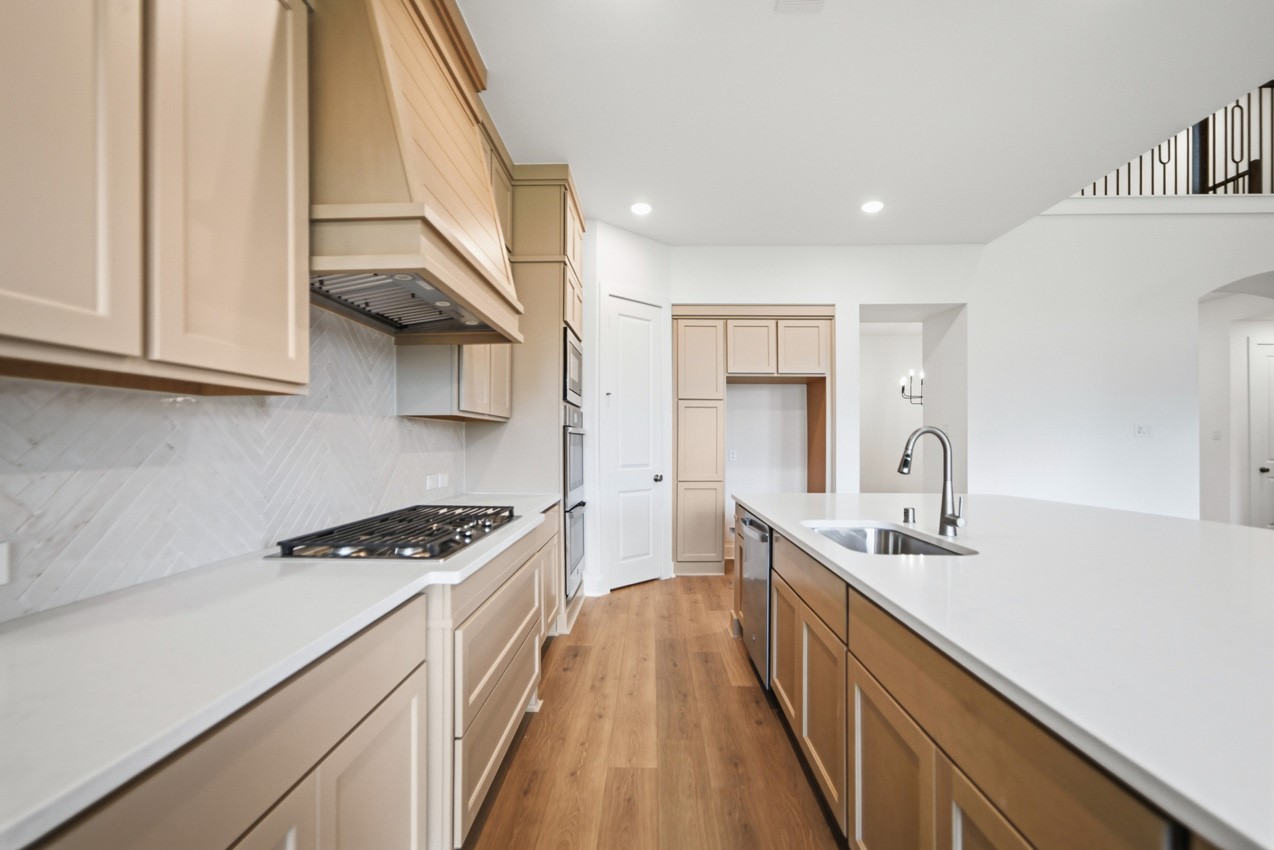 Chef-inspired kitchen featuring a gas cooktop, built-in appliances, and an efficient workspace.