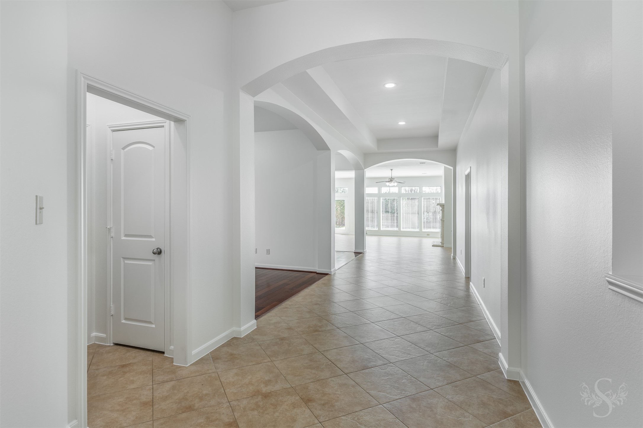 Designed with an airy, open feel, the expansive entry flows effortlessly into the light-filled family room and kitchen beyond. Arched openings, elevated ceilings and wide sightlines enhance the homes inviting atmosphere and thoughtful design. Designed with an airy, open feel, the expansive entry flows effortlessly into the light-filled family room and kitchen beyond. Arched openings, elevated ceilings and wide sightlines enhance the homes inviting atmosphere and thoughtful design.