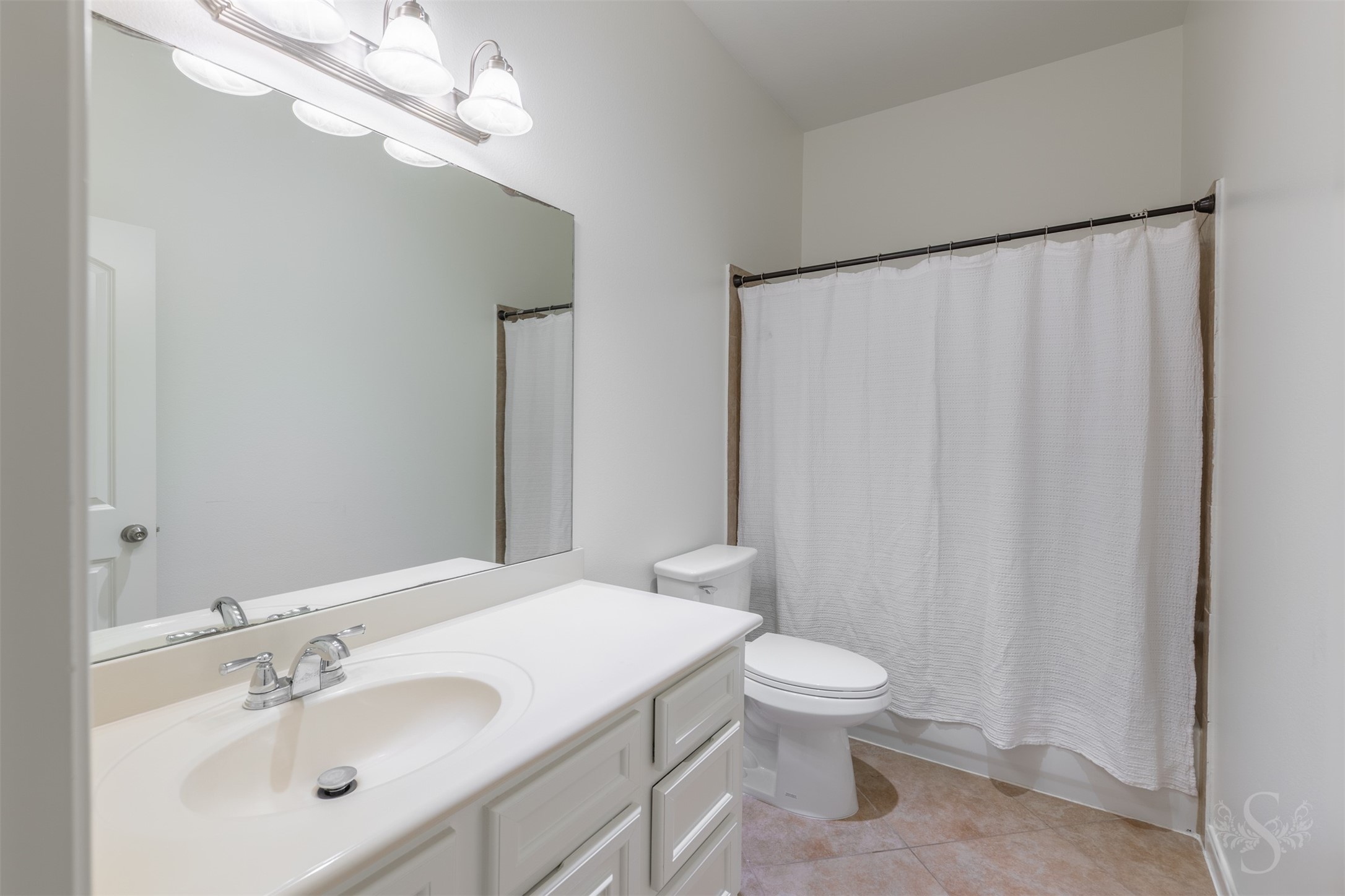 Well-appointed secondary bath features a stylish vanity with granite countertop and plenty of storage. The tub and shower combination provides convenience for both family and guests