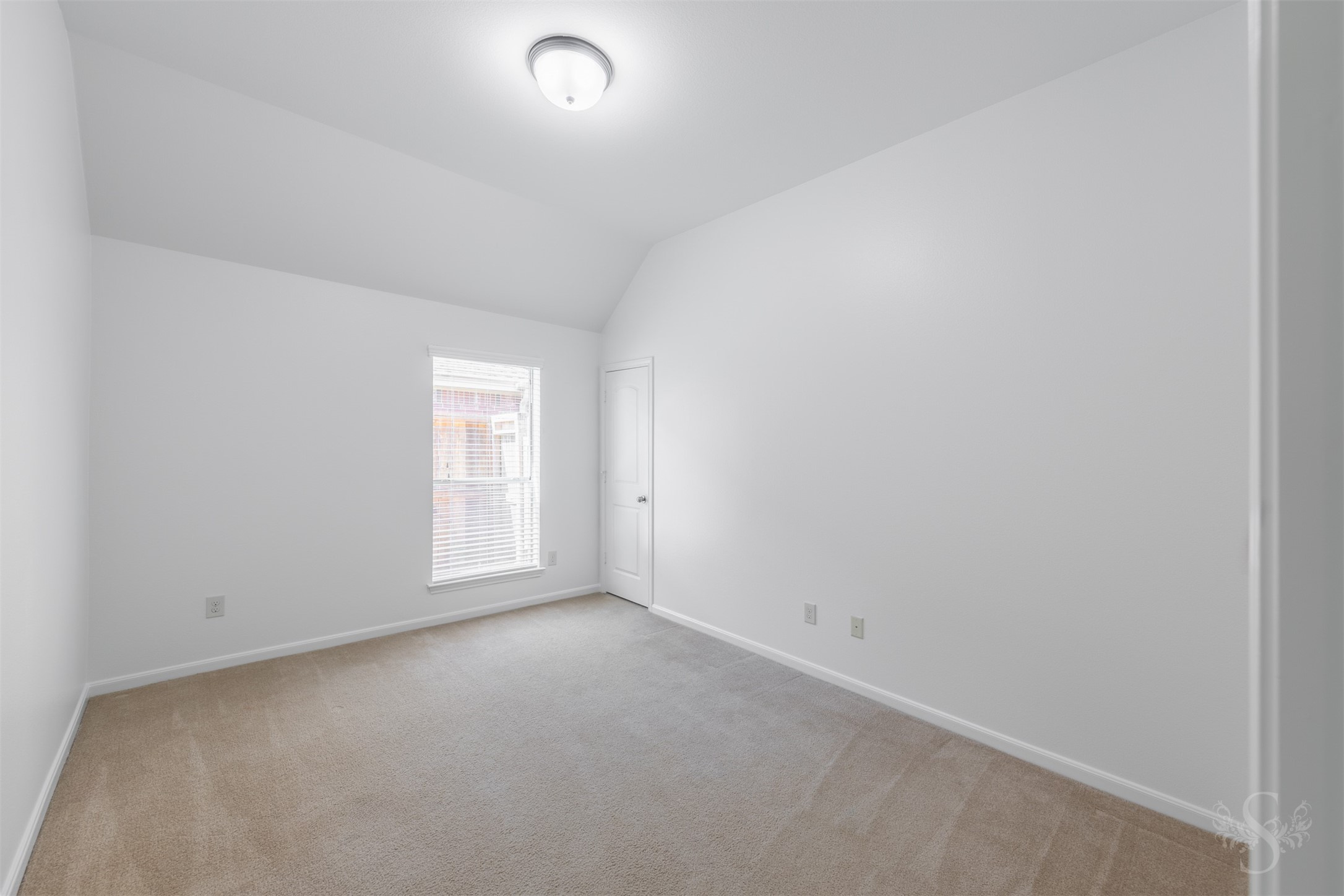 This secondary bedroom features elevated ceilings, plush carpeting and a large window that bring in soft natural light. Generous space and a comfortable layout make it ideal for family or guests.