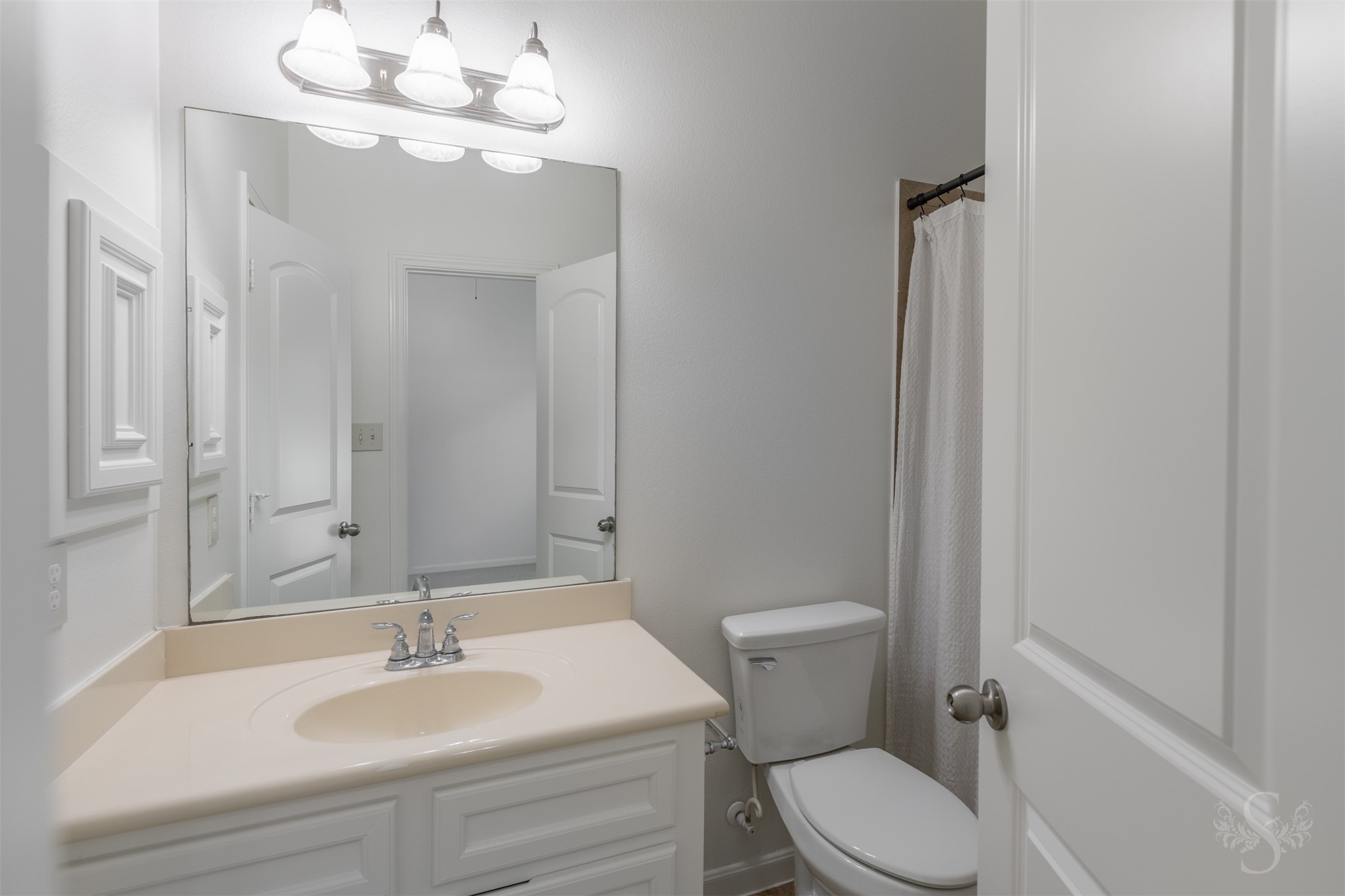 Well-appointed secondary bath features a stylish vanity with granite countertop and plenty of storage. The tub and shower combination provides convenience for both family and guests