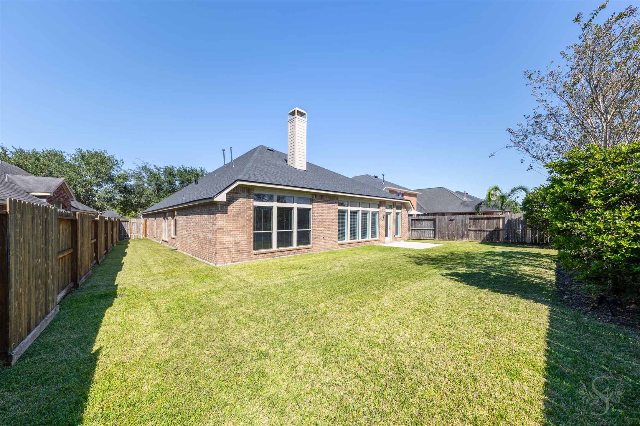 The expansive backyard offers a lush lawn and beautiful landscaping, creating a peaceful outdoor setting. Mature plantings add color and privacy while leaving plenty of room for recreation.