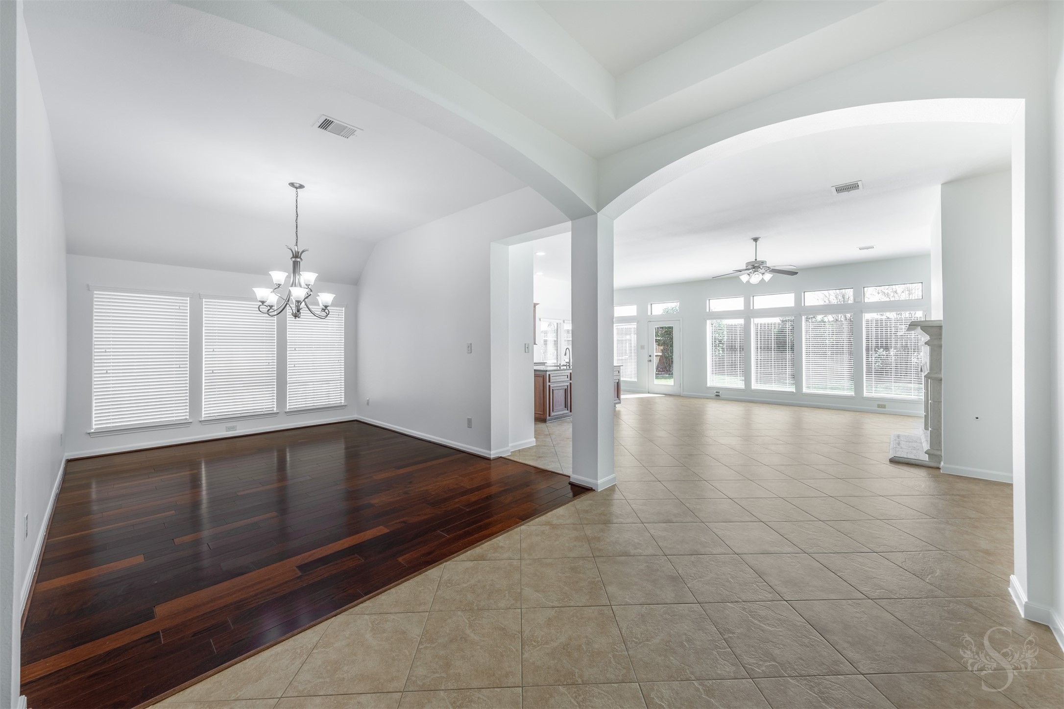 Framed by elegant archways, the formal dining room offers a spacious setting for gatherings while remaining seamlessly connected to the heart of the home. Rich wood floors, elevated ceilings and wide sightlines enhance the homes open, inviting design. Framed by elegant archways, the formal dining room offers a spacious setting for gatherings while remaining seamlessly connected to the heart of the home. Rich wood floors, elevated ceilings and wide sightlines enhance the homes open, inviting design.