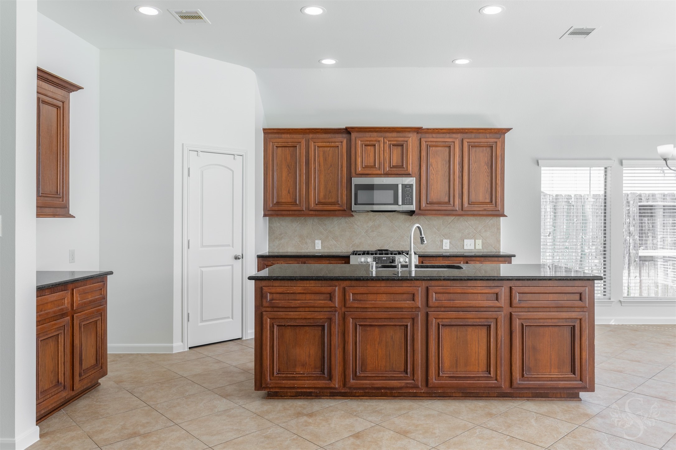 Chefs kitchen showcases gorgeous granite counters and island, stainless steel appliances and an abundance of cabinets for your storage needs.