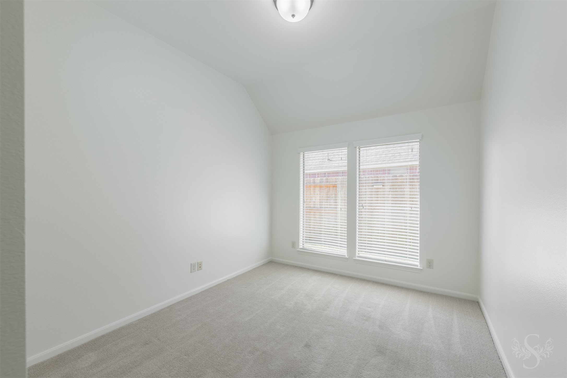 This versatile flex room offers a wonderful space for a playroom, homework area or hobbies. Two tall windows and a high ceiling create a bright, comfortable setting.