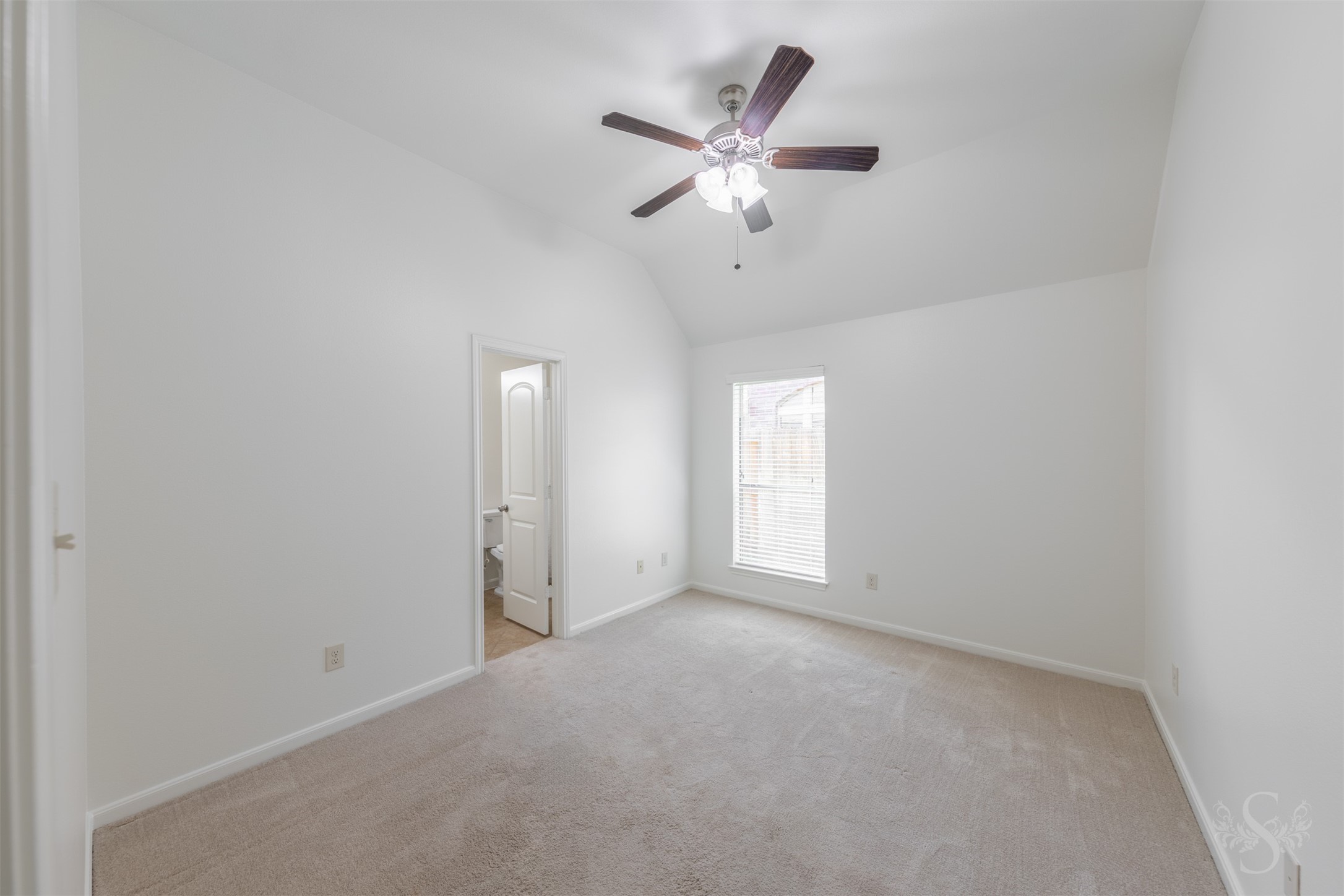 This secondary bedroom features elevated ceilings, plush carpeting and a window that bring in soft natural light. Generous space and a comfortable layout make it ideal for family or guests.