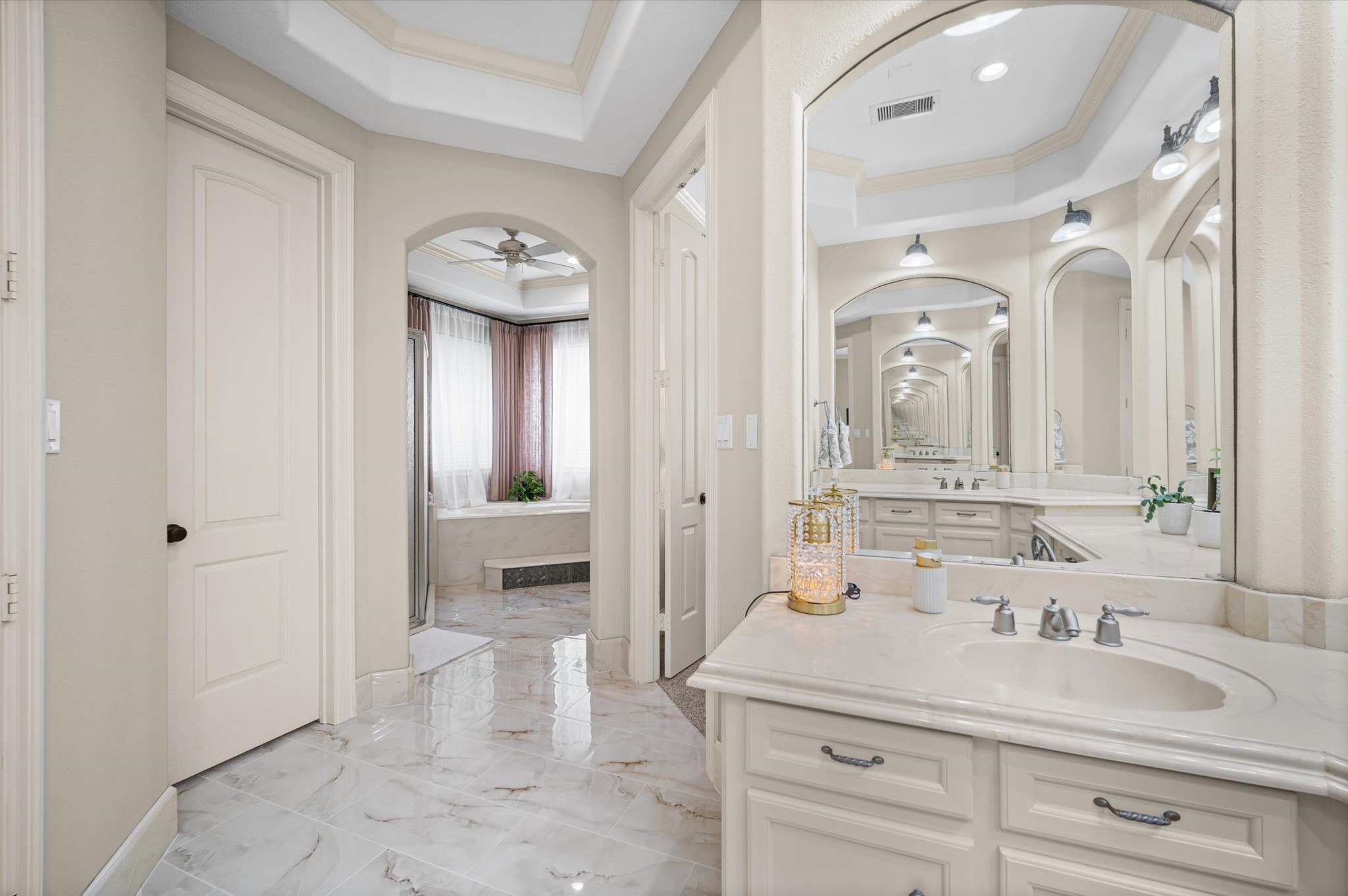Expansive primary bath with extensive vanity space and custom cabinetry